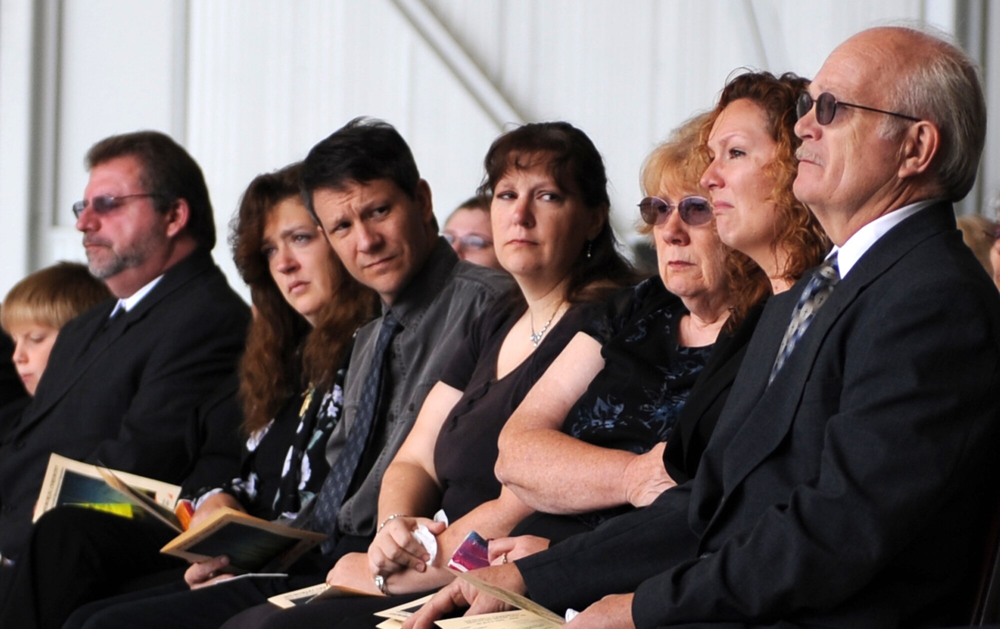 MOUNTAIN HOME AIR FORCE BASE, Idaho - The family of Master Sgt. Richard Caron comfort each other during a memorial ceremony at Hangar 1331 July 9. Sergeant Caron was with the 366th Aircraft Maintenance Squadron and passed away in Mountain Home July 4. (U.S. Air Force photo/Airman 1st Class Renishia Richardson)