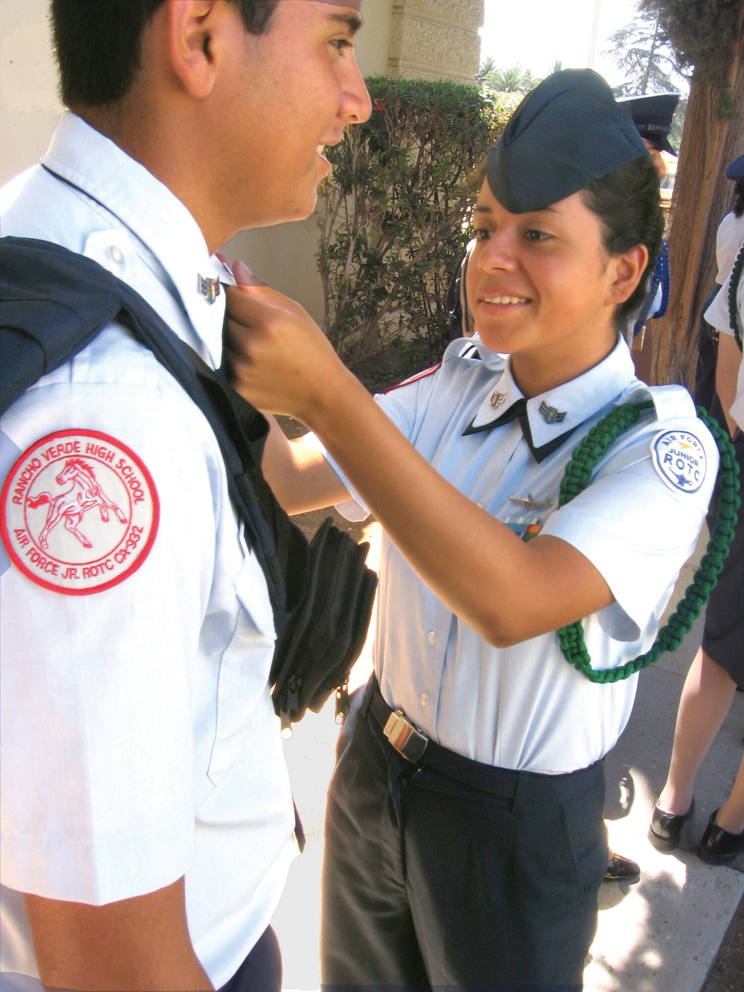 SELF INSPECTION: Junior ROTC Cadet Airman 1st Class Randy Larin adjusts the rank of fellow cadet Alex Lazo before their graduation ceremony at the Cultural Resource Center on base. Both students are incoming sophomores at Rancho Verde High School in Moreno Valley, Calif. (U.S. Air Force photo by Staff Sgt. David K. Flaherty)