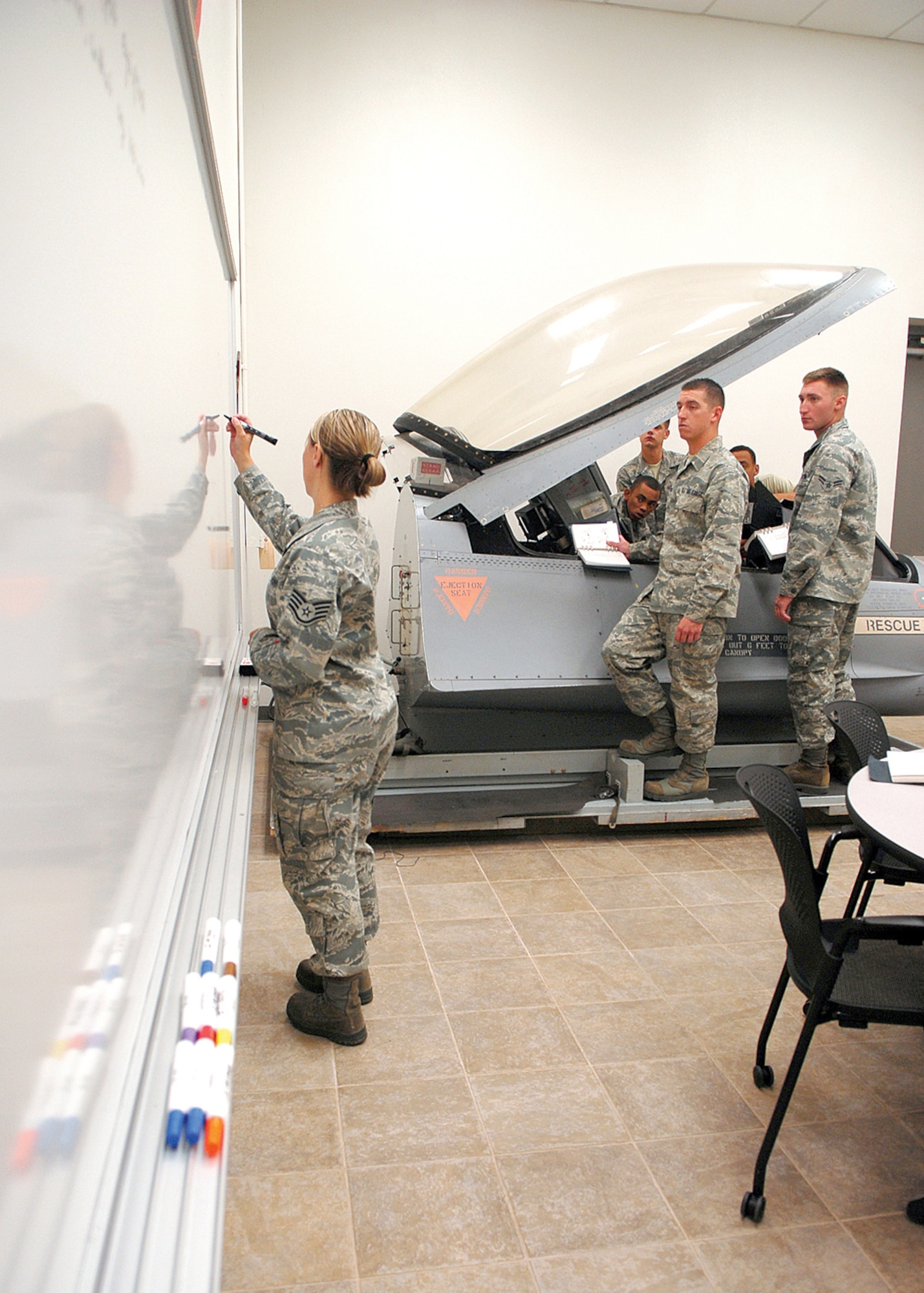 Staff Sgt. Heather Dolar, Detachment 12, 372nd Training Squadron Tactical Aircraft Maintenance instructor, instructs students of the MRA program at Bldg. 219. (U.S. Air Force photo/ Airman 1st Class Ronifel Yasay)