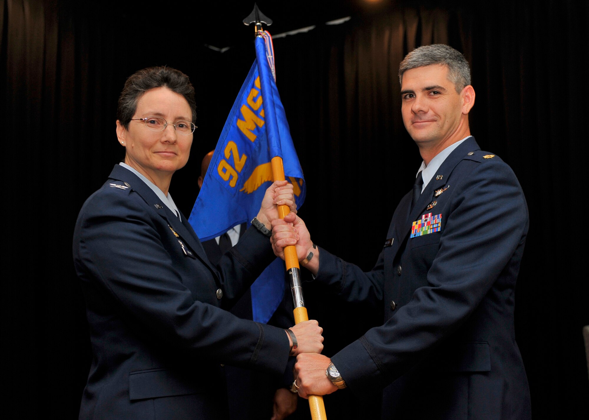 Maj. Michael (Shane) Watson, 92nd Contracting Squadron Commander, accepts the ceremonial guidon from Col. Suzanne Filion, 92nd Mission Support Group commander, during the 92nd CONS Change of Command Ceremony at the Deel Community Center June 23. (U.S. Air Force photo / Senior Airman Joshua K. Chapman))