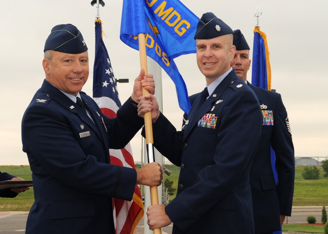 BUCKLEY AIR FORCE BASE, Colo. – Lt. Col. James Jablonski assumes command of the 460th Medical Operations Squadron in a traditional passing of the squadron flag from Col. Michael Chyrek, 460th Medical Group commander, during an official ceremony July 9.  Lt. Col. Jerry Lawson relinquished command and will move on to Travis Air Force Base, Calif. (U.S. Air Force photo by Senior Airman Randi Flaugh)
 

