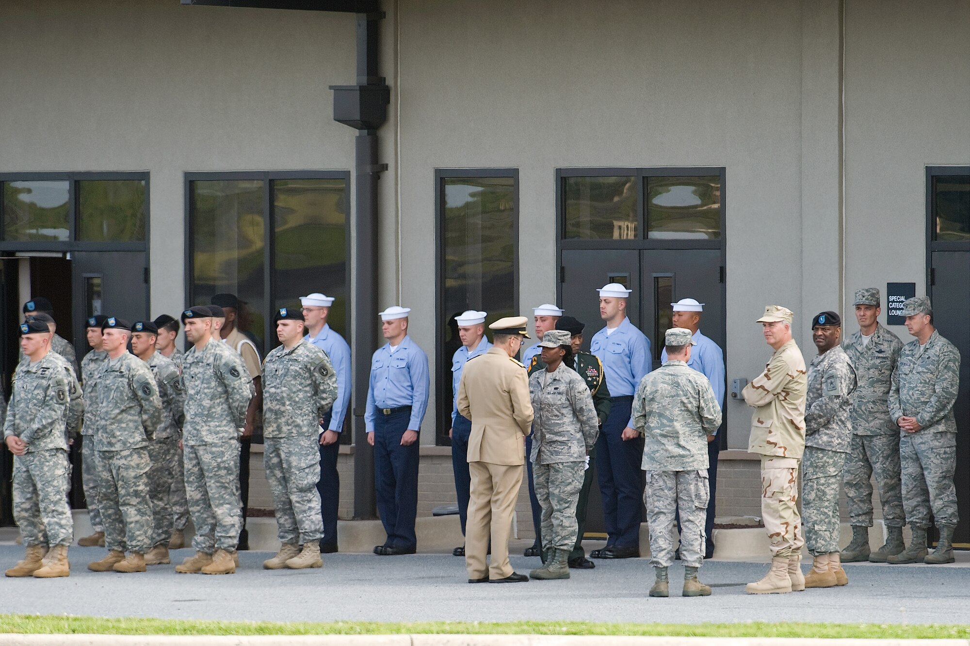 Navy Admiral Mike Mullen, chairman of the Joint Chiefs of Staff, shows his appreciation to the military members taking part in the Dignified Transfer held at Dover AFB July 8. (U.S. Air Force photo/Roland Balik)