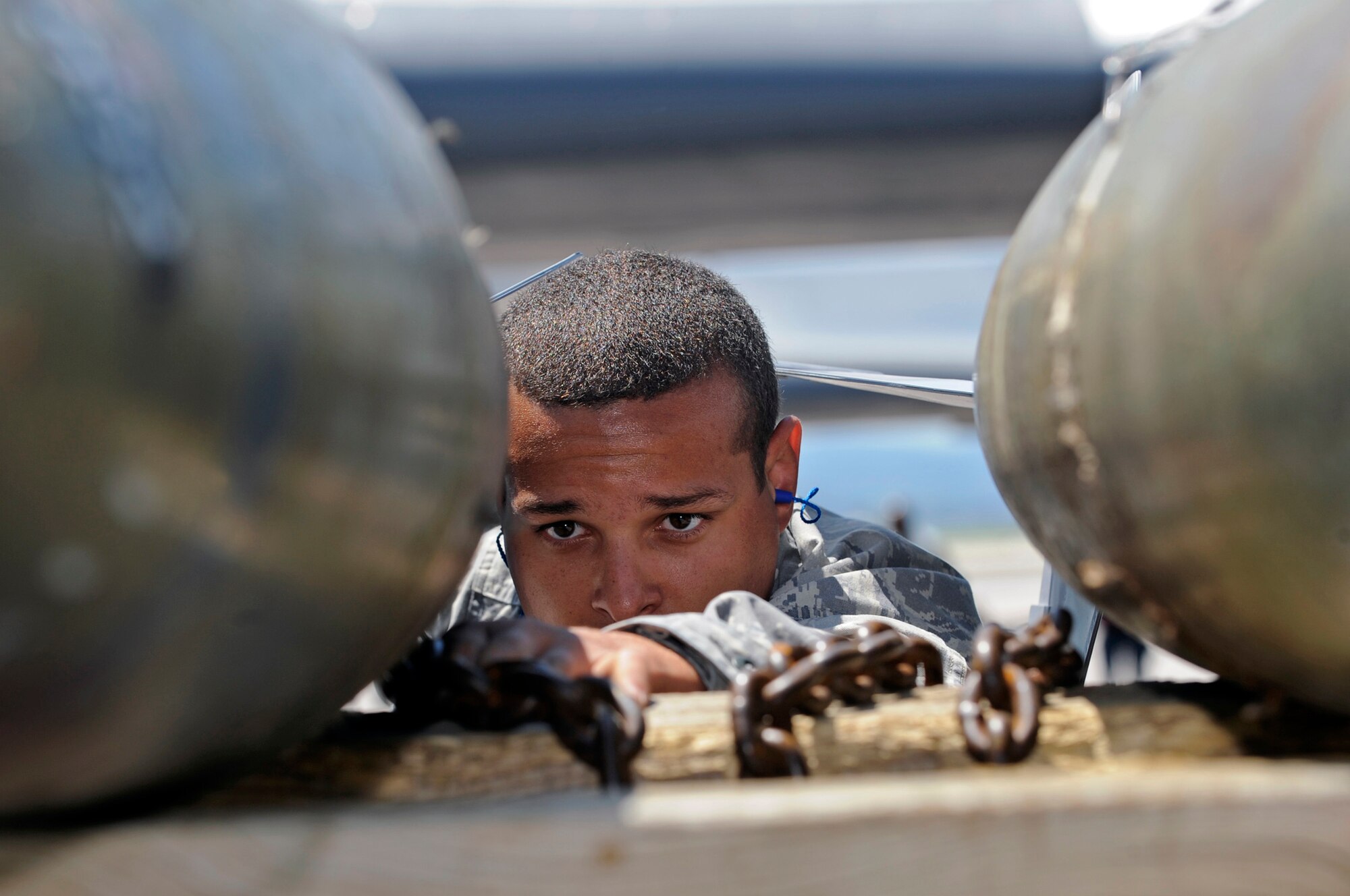Airman 1st Class Phillip Rhinehart, 28th Aircraft Maintenance Squadron weapons load crew member, prepares MK-82 weapons to be placed on a jammer during a load competition here, July 7. The two teams competing were evaluated on dress and appearance, a 25-question written test and a composite tool kit inspection, along with the weapons load. (U.S. Air Force photo/Airman 1st Class Matthew Flynn)