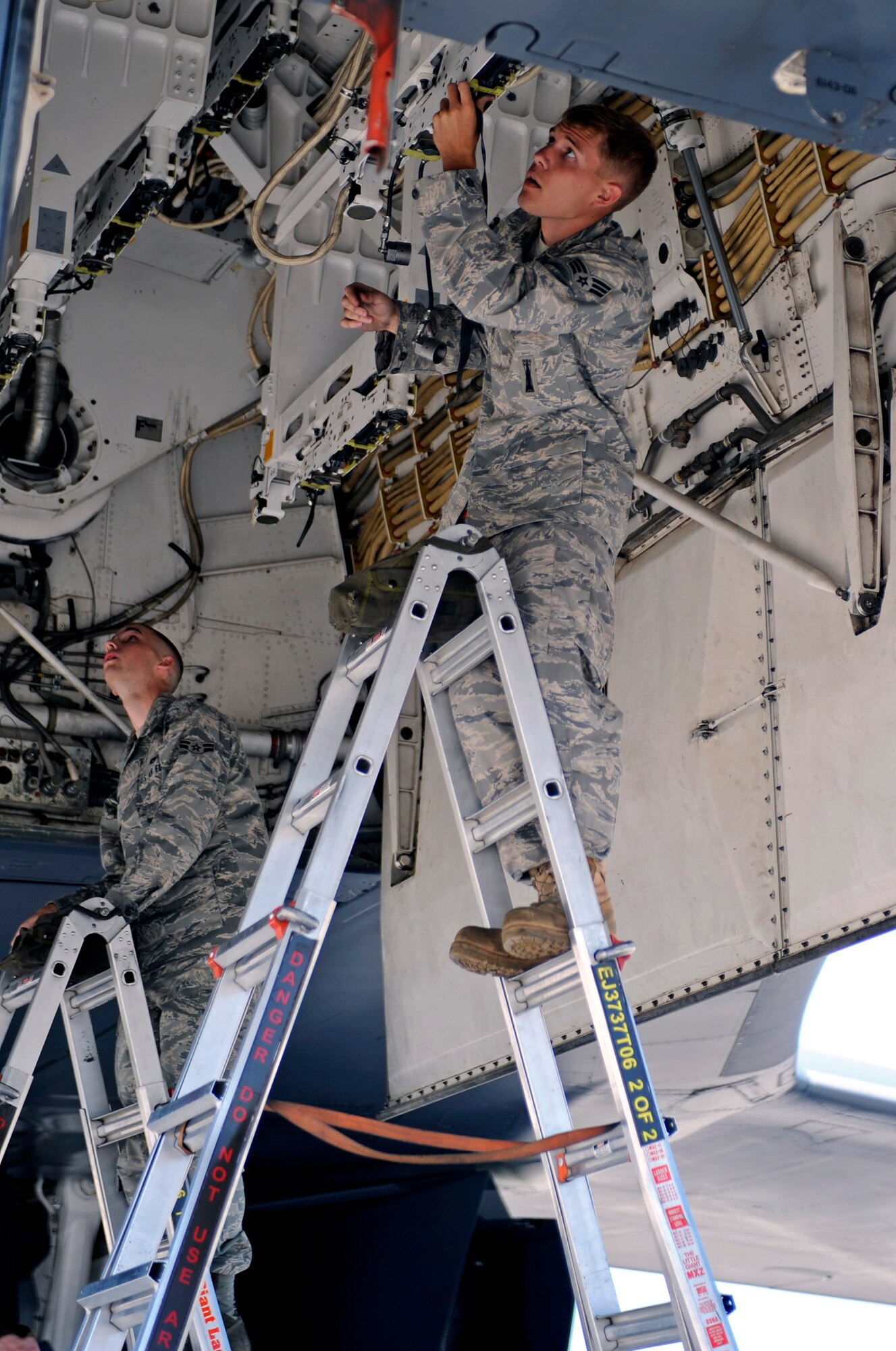 (Right) Senior Airman Matthew Pence and Airman 1st Class Matthew Beard, 28th Aircraft Maintenance Squadron load crew members, prepare the bomb bay of a B-1B Lancer for MK-82 weapons during a load competition here, July 7.  Traditionally used as a means for weapons Airmen to maintain job proficiency, the load competition featured two, four-man teams representing both the 34th and 37th Bomb Squadron Aircraft Maintenance Units. (U.S. Air Force photo/Airman 1st Class Matthew Flynn)