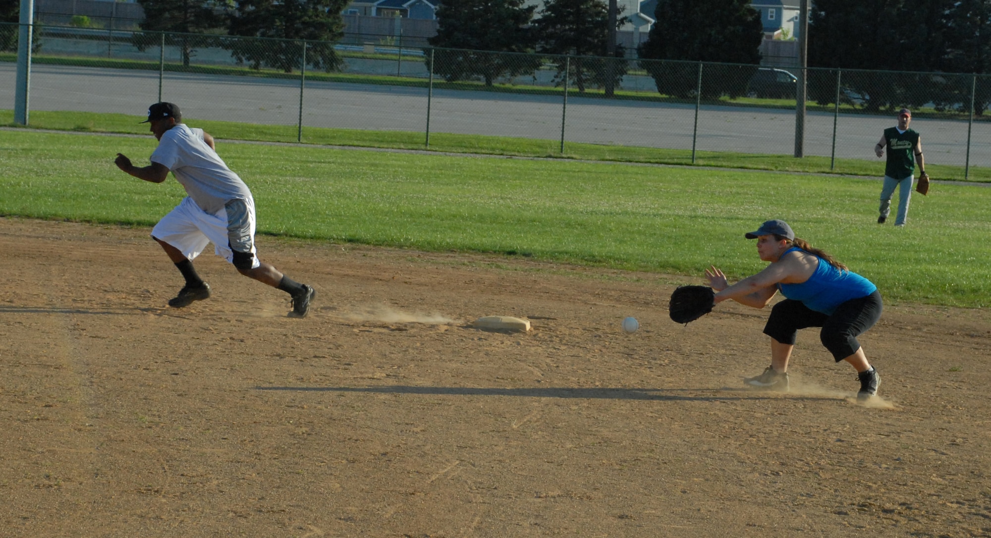 Pamela Coats, 436th Comptroller Squadron second baseman, catches a grounder as an Air Force Mortuary Affairs Operations Center player runs for third.  AFMAO defeated 436th CPTS 13-3.  (US Air Force photo/Staff Sgt. Chad Padgett)