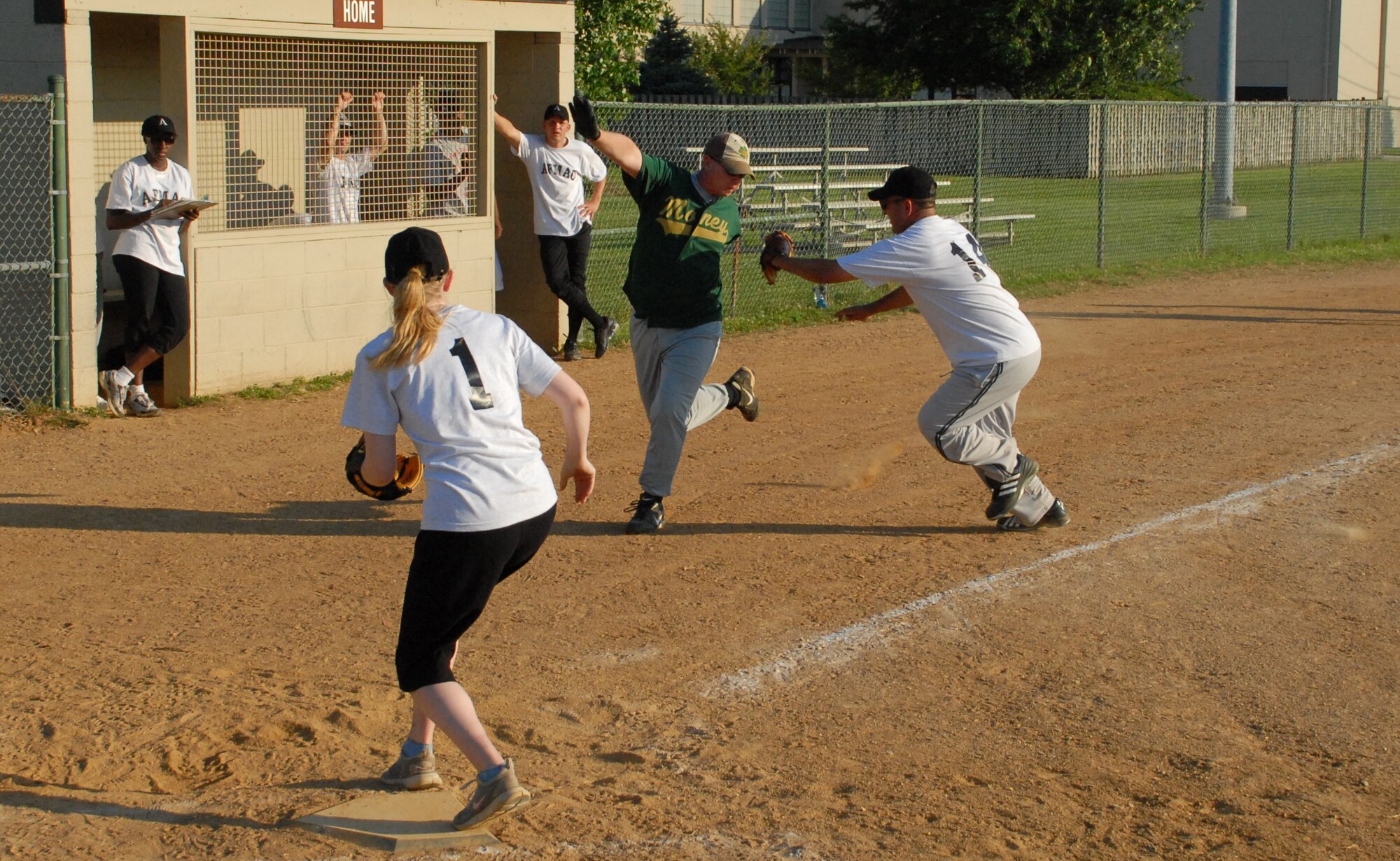 (Right) Elmer Feliciano, Air Force Mortuary Affairs Operations Center pitcher, tags out Nyle Smith, 436th Comptroller Squadron, July 7.   AFMAO defeated 436th CPTS 13-3.  (US Air Force photo/Staff Sgt. Chad Padgett)