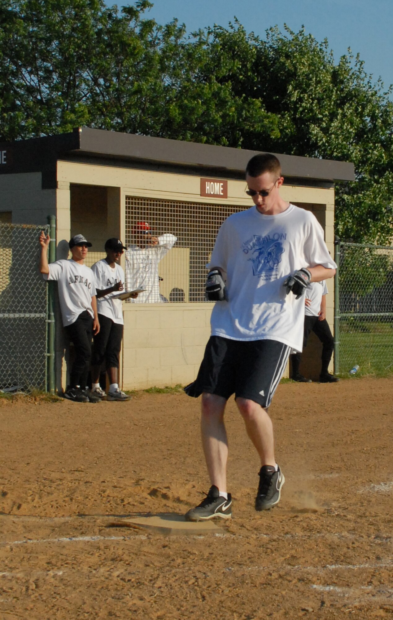 Christopher Smith, 436th Comptroller Squadron softball player, scores a run against the Air Force Mortuary Affairs Operations Center July 7.  AFMAO defeated 436th CPTS 13-3.  (US Air Force photo/Staff Sgt. Chad Padgett)