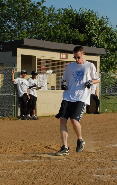 Christopher Smith, 436th Comptroller Squadron softball player, scores a run against the Air Force Mortuary Affairs Operations Center July 7.  AFMAO defeated 436th CPTS 13-3.  (US Air Force photo/Staff Sgt. Chad Padgett)