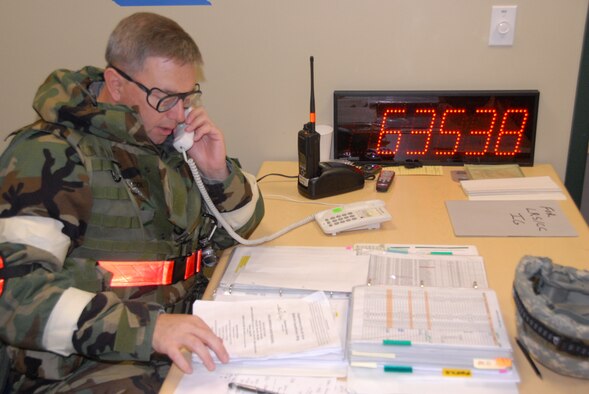 Lt. Col. John Hutter, LRS Commander, checks on the status of personnel and equipment after a simulated missile attack during the ORI. (photo by Master Sgt. Allen Pickert)