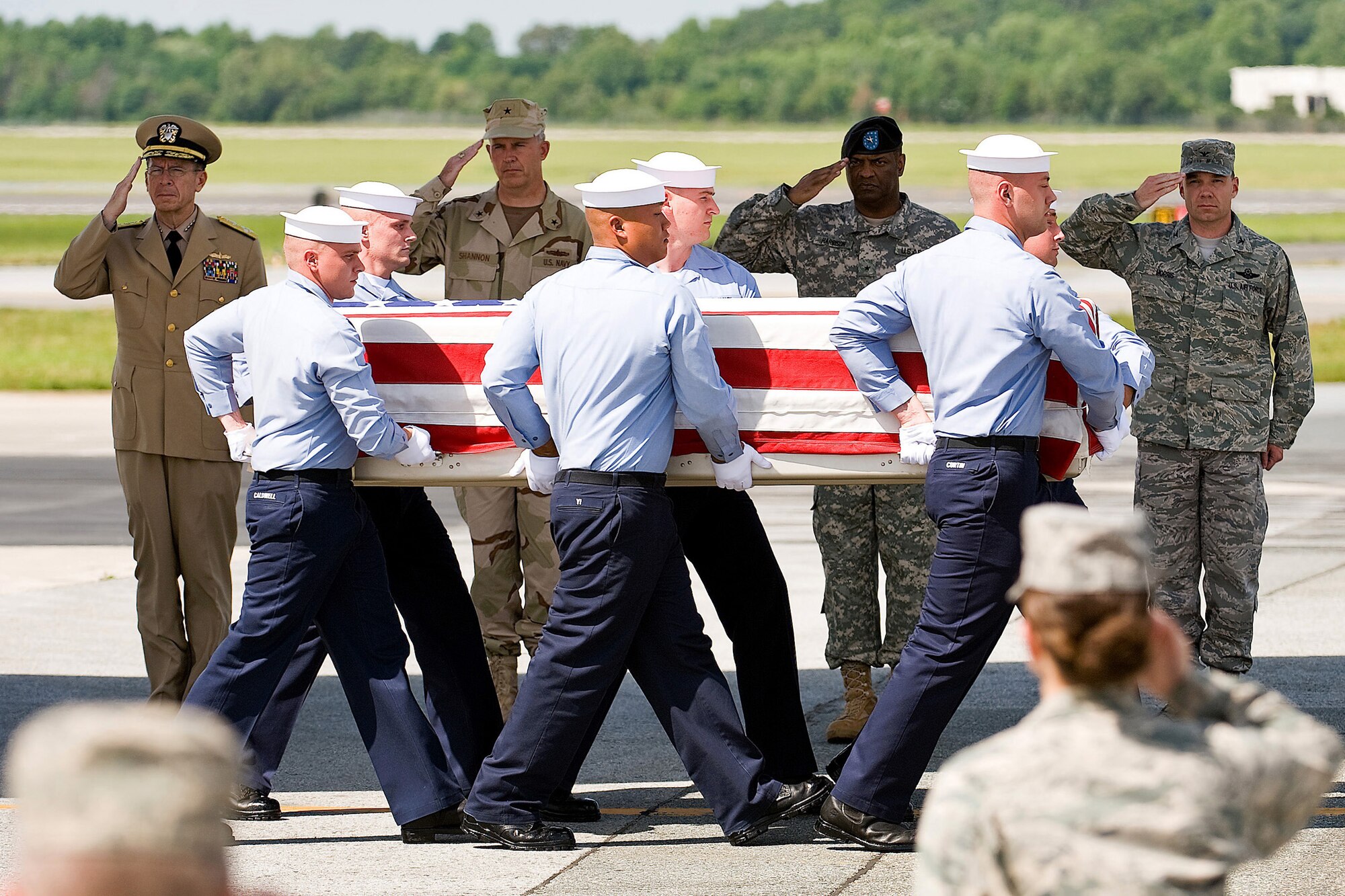 A Navy team transfers the remains of Navy Petty Officer 2nd Class Tony M. Randolph as Navy Adm. Mike Mullen, Navy Rear Adm. James J. Shannon, Army Brig. Gen. Michael T. Harrison Sr. and Col. Manson Morris pay their respects July 8 at Dover Air Force Base, Del. Admiral Mullen is the chairman of the Joint Chiefs of Staff, and Admiral Shannon is the commander of the Naval Warfare Center. General Harrison is the director of Joint and Futures in the Office of the Deputy Chief of Staff, G8, Headquarters, Department of the Army. Colonel Morris is the 436th Airlift Wing commander. (U.S. Air Force photo/Roland Balik)