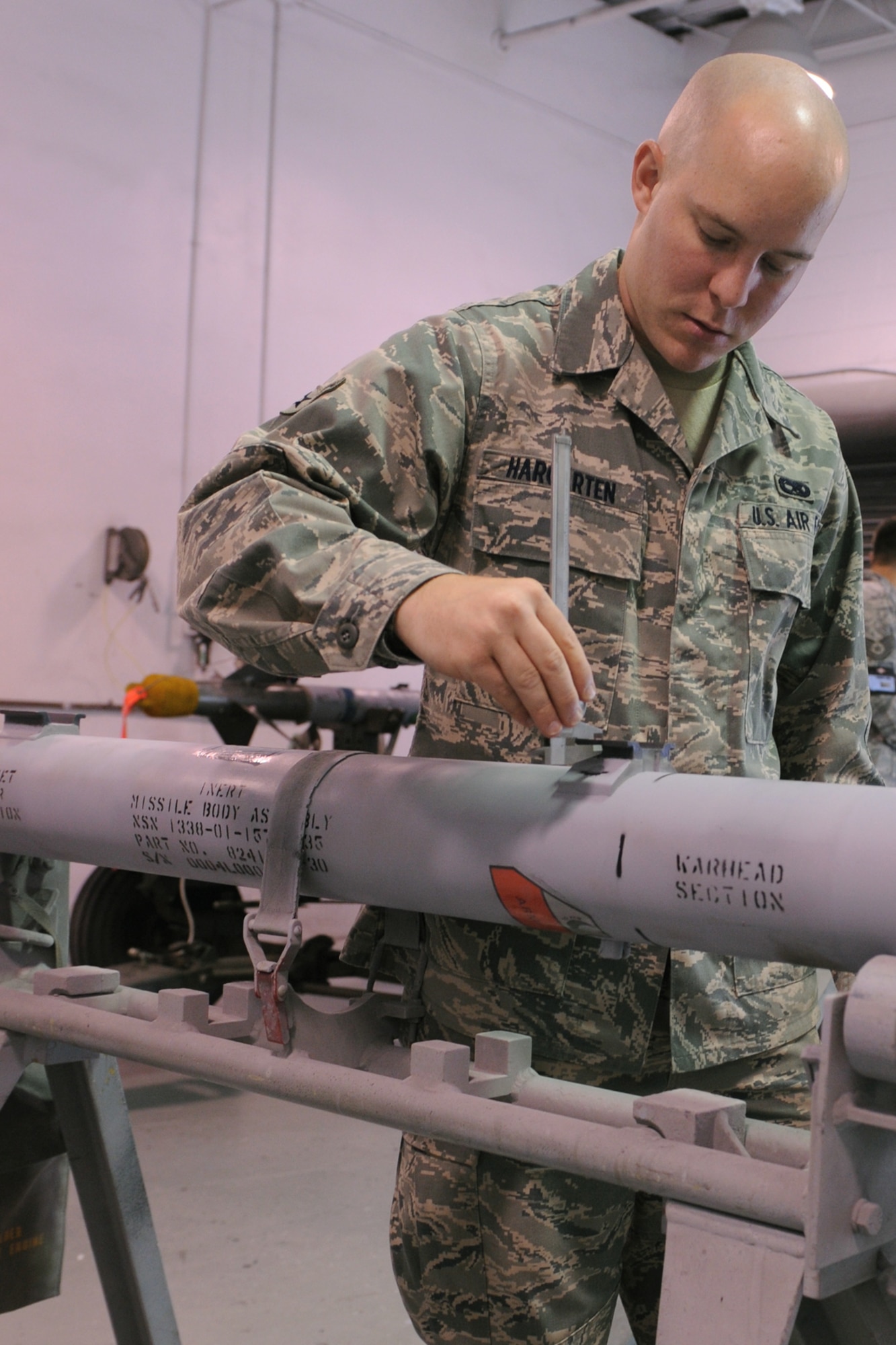 Airman Patrick Hargarten, 4th Equipment Maintenance Squadron munitions systems journeyman, measures a hanger checking for serviceability during a 20-flight inspection on Seymour Johnson Air Force Base, N.C., July 7, 2009. A 20-flight inspection occurs after a weapon has been flown a maximum of 20 times. The hangers attach the missile to the aircraft. (U.S. Air Force photo by Airman 1st Class Whitney S. Lambert) 