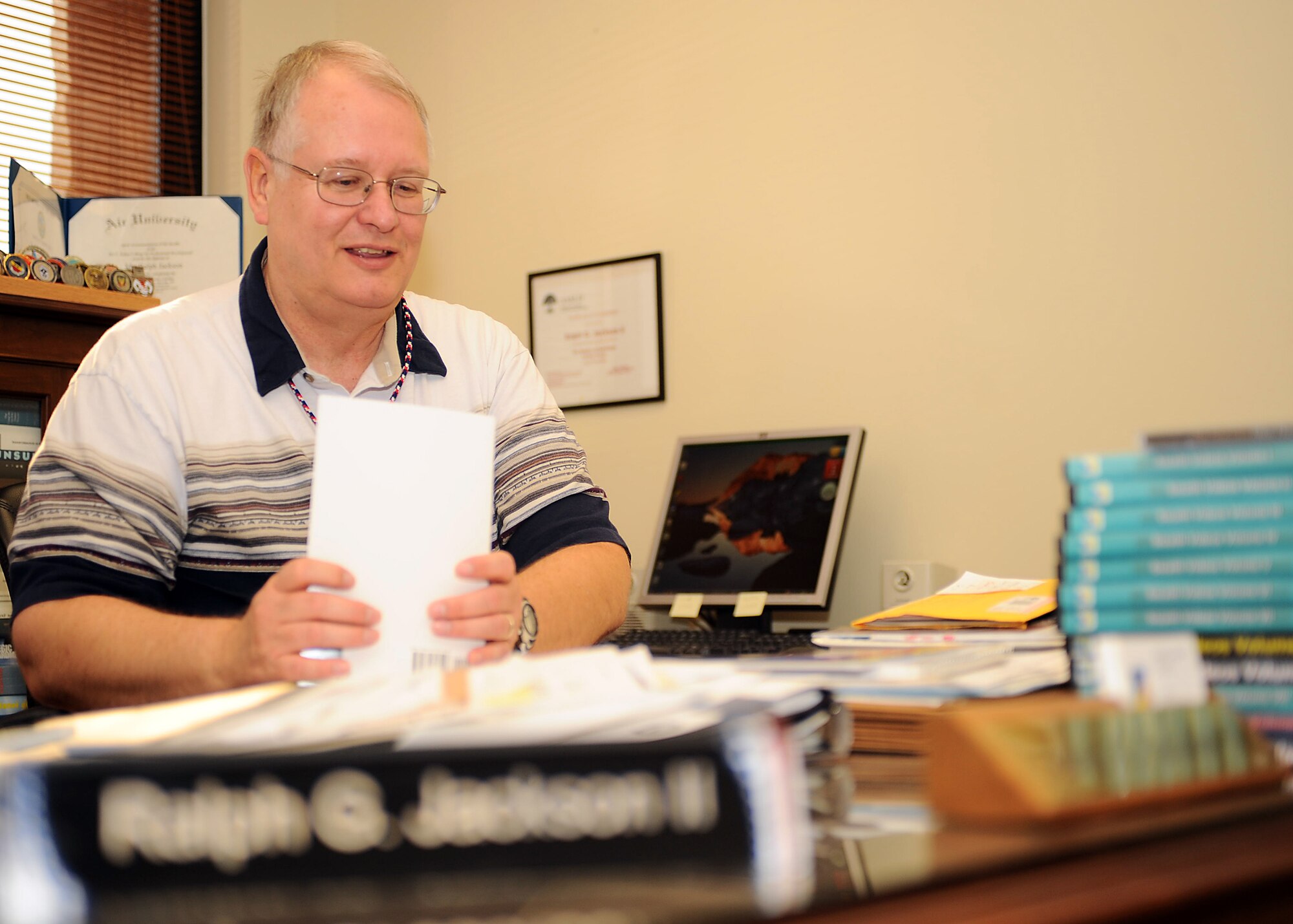 Mr. Ralph Jackson, the new 49th Fighter Wing Historian, goes over paperwork at his desk in the Wing Historian Office at Holloman Air Force Base, N.M., July 1. Mr. Jackson brings years of experience to Holloman to document the 49 FW mission. (U.S. Air Force photo/ Airman 1st Class DeAndre Curtiss)