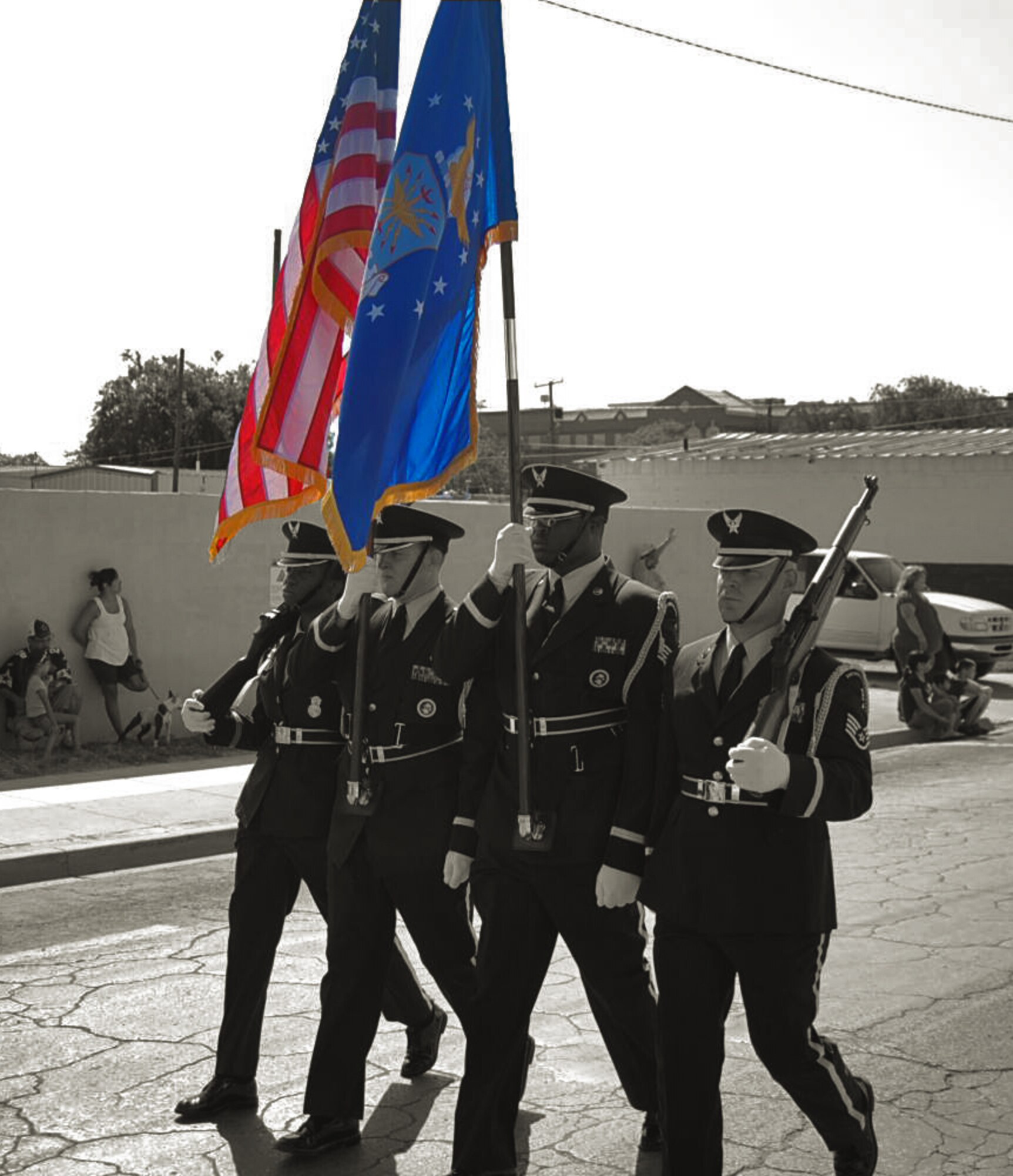 LAUGHLIN AIR FORCE BASE, Texas – Lauhglin Honor Guard members present the colors during the Fourth of July parade in Del Rio. As a part of the parade, there were more than 50 Airmen that marched as a flight, as well as a group of Airmen from the 47th Security Forces Squadron and many other Laughlin members came out to celebrate Independence Day with the Del Rio community. Col. Jeffrey McDaniels, 47th Flying Training Wing commander, took part in the parade as well as the evenings keynote speaker. (U.S. Air Force photo illustration by Airman 1st Class Sara Csurilla, photo by Tech. Sgt. Joel Langton)