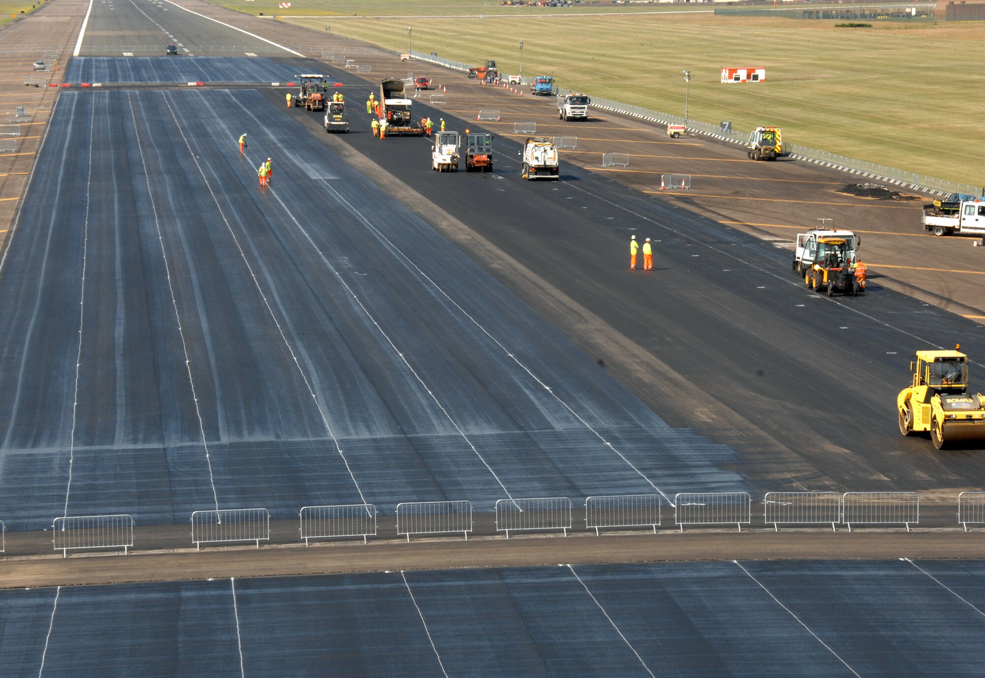 48th Fighter Wing Airmen work with local contractors to strip, fill and resurface a portion of the RAF Lakenheath airfield July 1, 2009. The project was in planning for about a year and cost $1.2 million. The repairs are part of a greater annual maintenance plan that includes repainting and rubber removal. (U.S. Air Force photo by Tech. Sgt. Christopher A. Campbell)