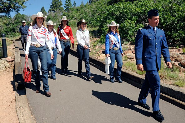 Cadet 2nd Class Joseph Scioscia III takes Pikes Peak or Bust Rodeo queens on a tour of the U.S. Air Force Academy Visitor Center and Cadet Chapel July 8. The Pikes Peak or Bust Rodeo will take place at the Norris-Penrose Event Center in Colorado Springs, Colo., July 8-11. July 11 is Air Force Academy and Family Day at the Rodeo, which donates its proceeds to local military charities. (U.S. Air Force photo/Mike Kaplan)