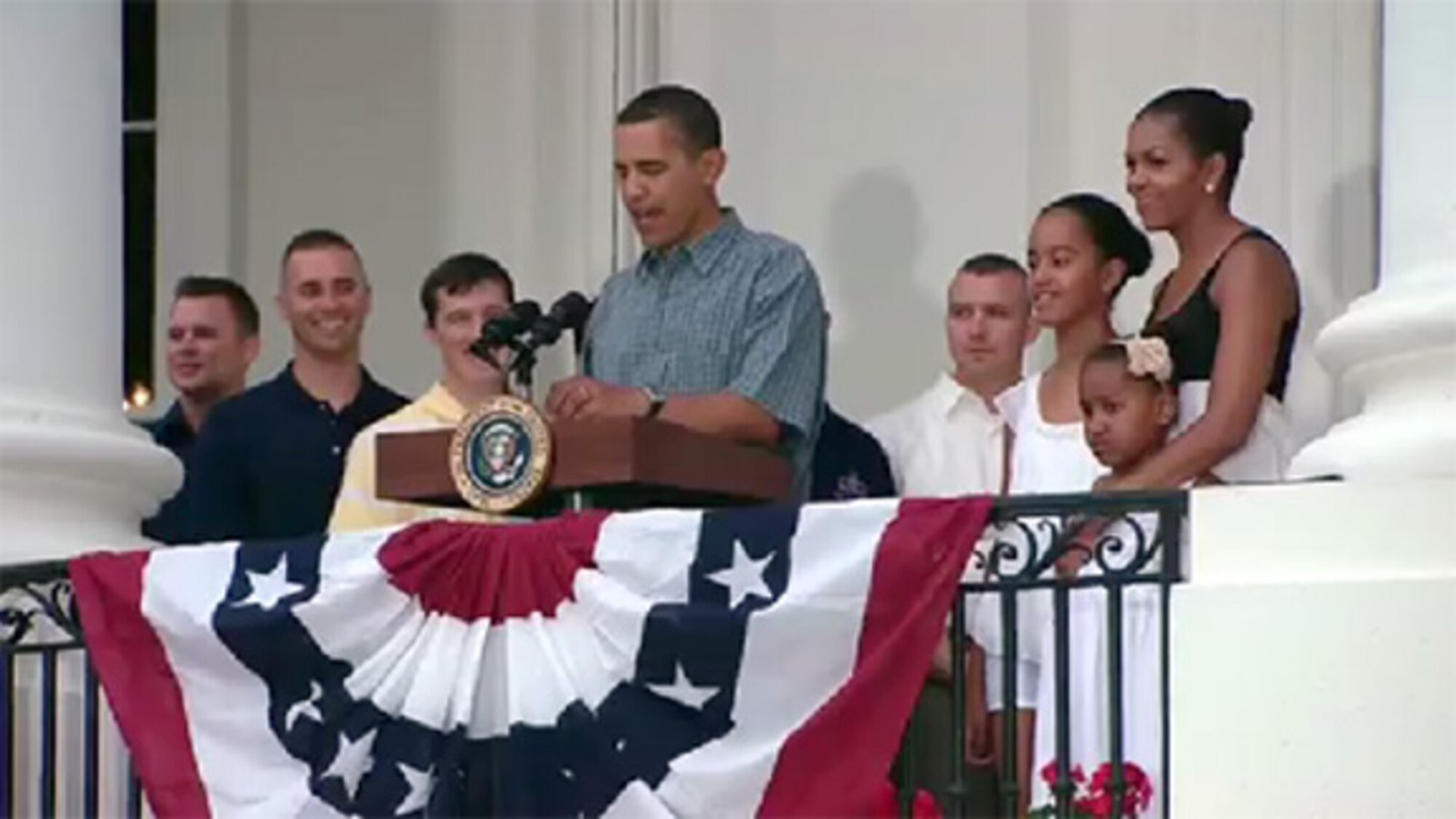 Tech. Sgt. Benjamin Horton (second from left), 775th Civil Engineer Squadron Explosive Ordinance Disposal technician, stands with President Barack Obama at
the White House on July 4, as part of a group.