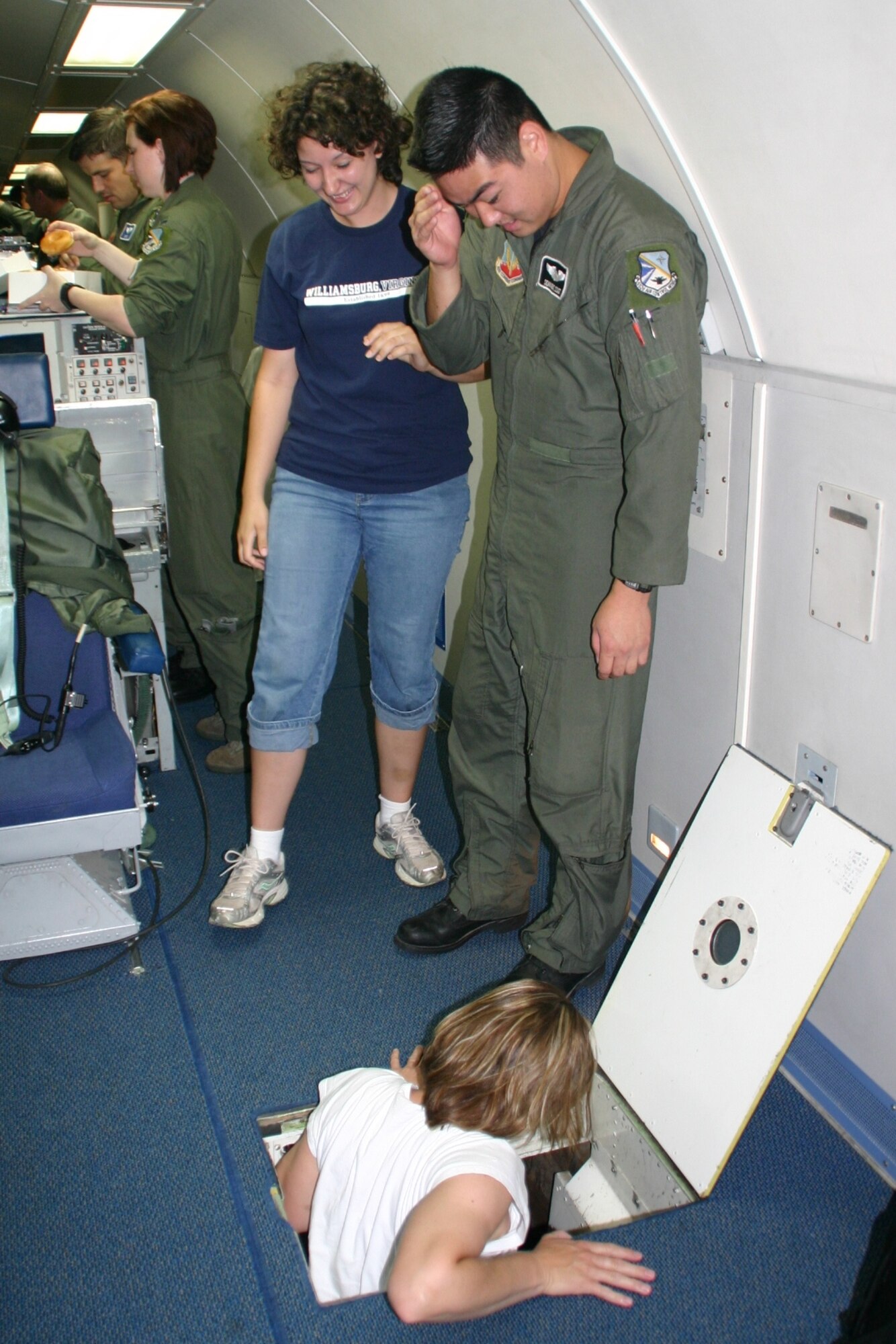 Ms. Misty Huch prepares to take a tour of the lower lobe of the aircraft during pre-flight preparations. All of the spouses were eager to see and learn as much as possible during the experience. Photo courtesy of 1st Lt. Kinder Blacke.