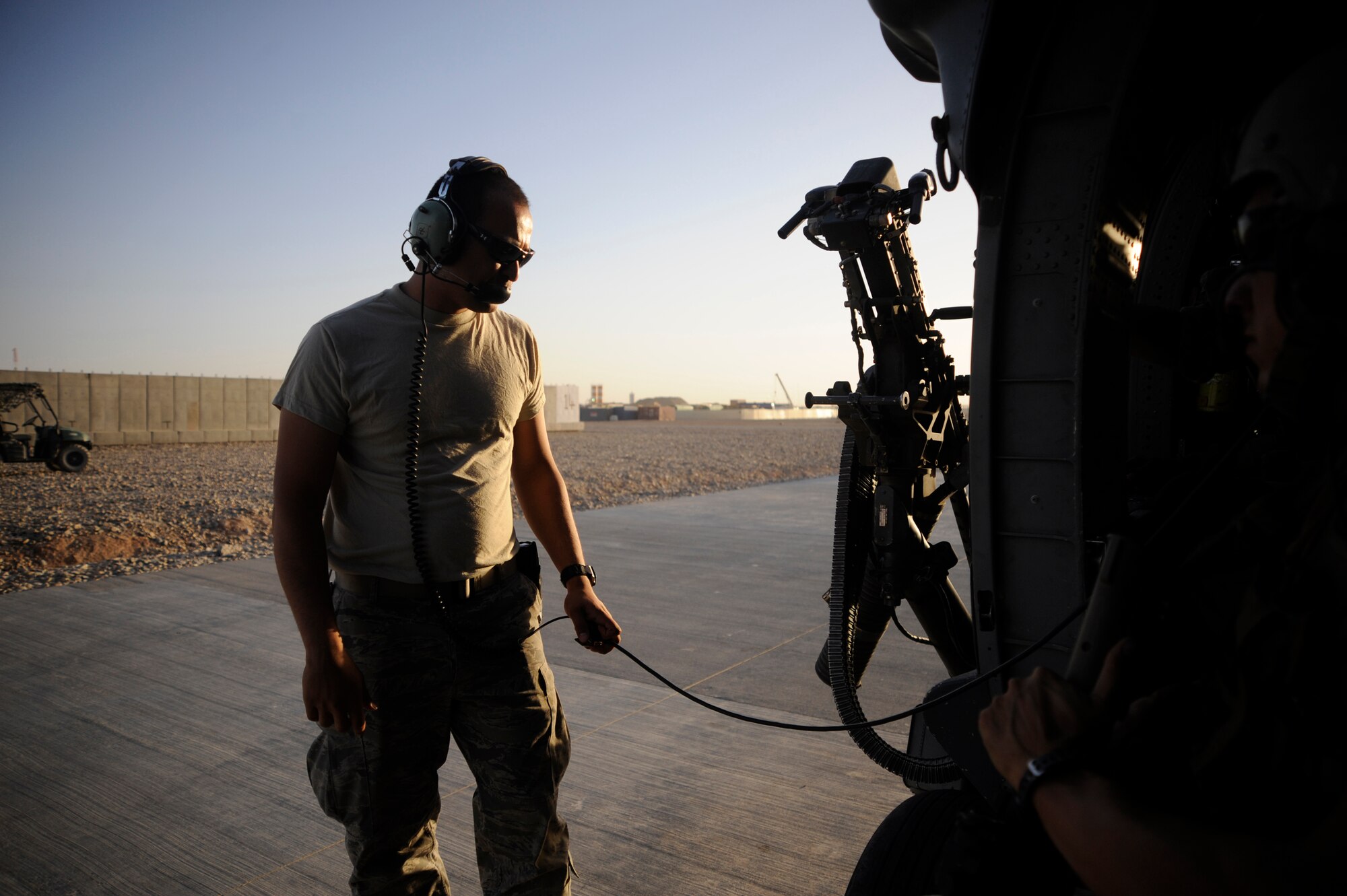 U.S. Air Force Senior Airman Lee Devore, 129th Expeditionary Rescue Squadron maintainer, helps to prepare an HH-60G Pave Hawk for flight, June 27, 2009, Camp Bastion, Afghanistan. (U.S. Air Force Photo by Staff Sgt. Shawn Weismiller)