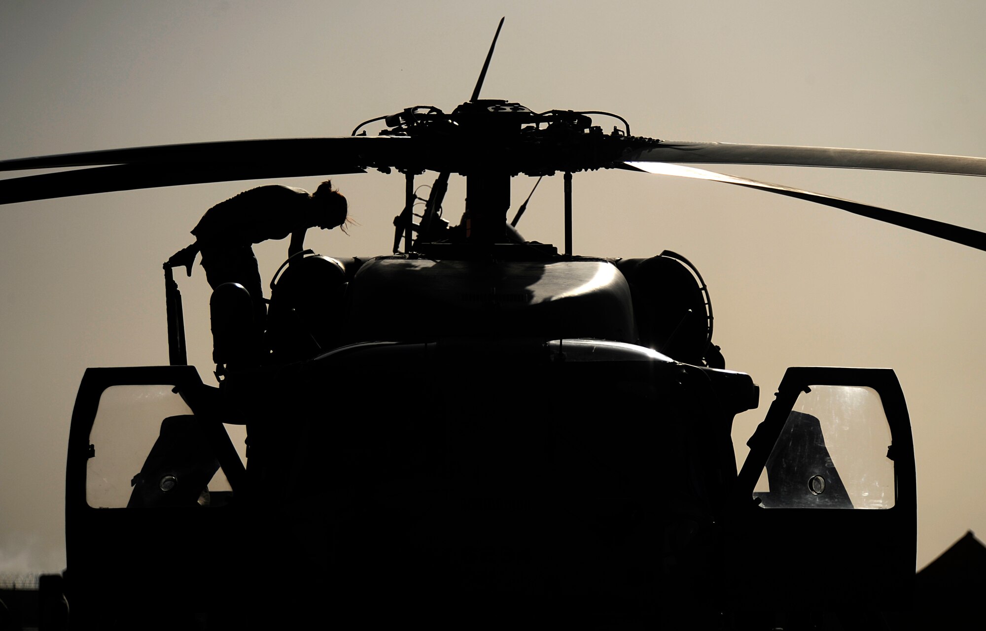 An Airman from the 129th Expeditionary Rescue Squadron conducts a preflight inspection of an HH-60G Pave Hawk, June 25, 2009, Camp Bastion, Afghanistan. (U.S. Air Force Photo by Staff Sgt. Shawn Weismiller)