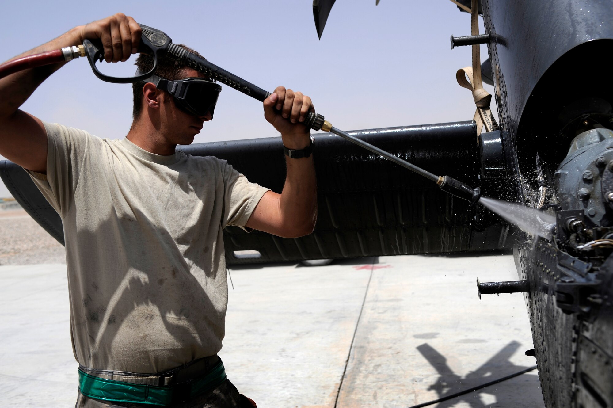 U.S. Air Force Senior Airman Donald Brody, 129th Expeditionary Rescue Squadron maintainer, cleans the tail section of an HH-60G Pave Hawk, June 24, 2009, Camp Bastion, Afghanistan. (U.S. Air Force Photo by Staff Sgt. Shawn Weismiller)