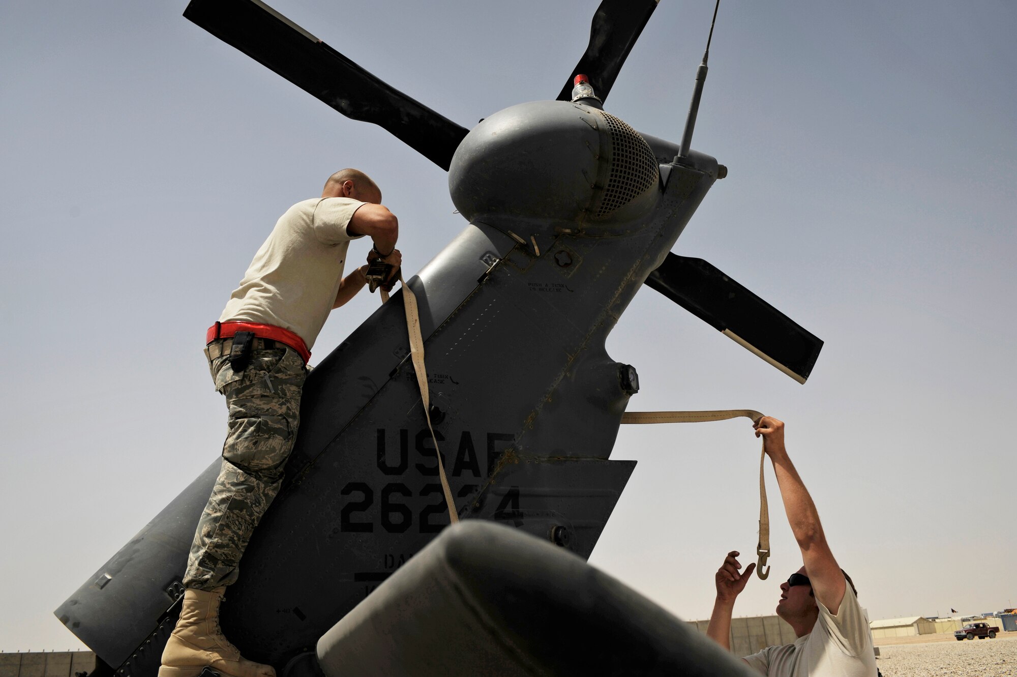 Maintainers from the 129th Expeditionary Rescue Squadron repair the tail section of an HH-60G Pave Hawk, June 24, 2009, Camp Bastion, Afghanistan. (U.S. Air Force Photo by Staff Sgt. Shawn Weismiller)