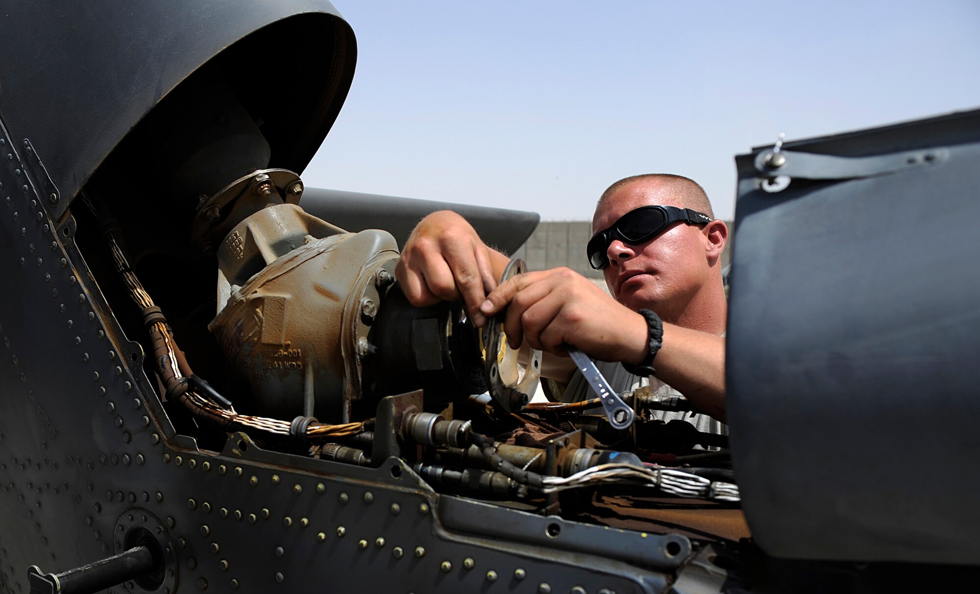 U.S. Air Force Staff Sgt. Jeremy Weninger, 129th Expeditionary Rescue Squadron maintainer, repairs the tail section of an HH-60G Pave Hawk, June 24, 2009, Camp Bastion, Afghanistan. (U.S. Air Force Photo by Staff Sgt. Shawn Weismiller)