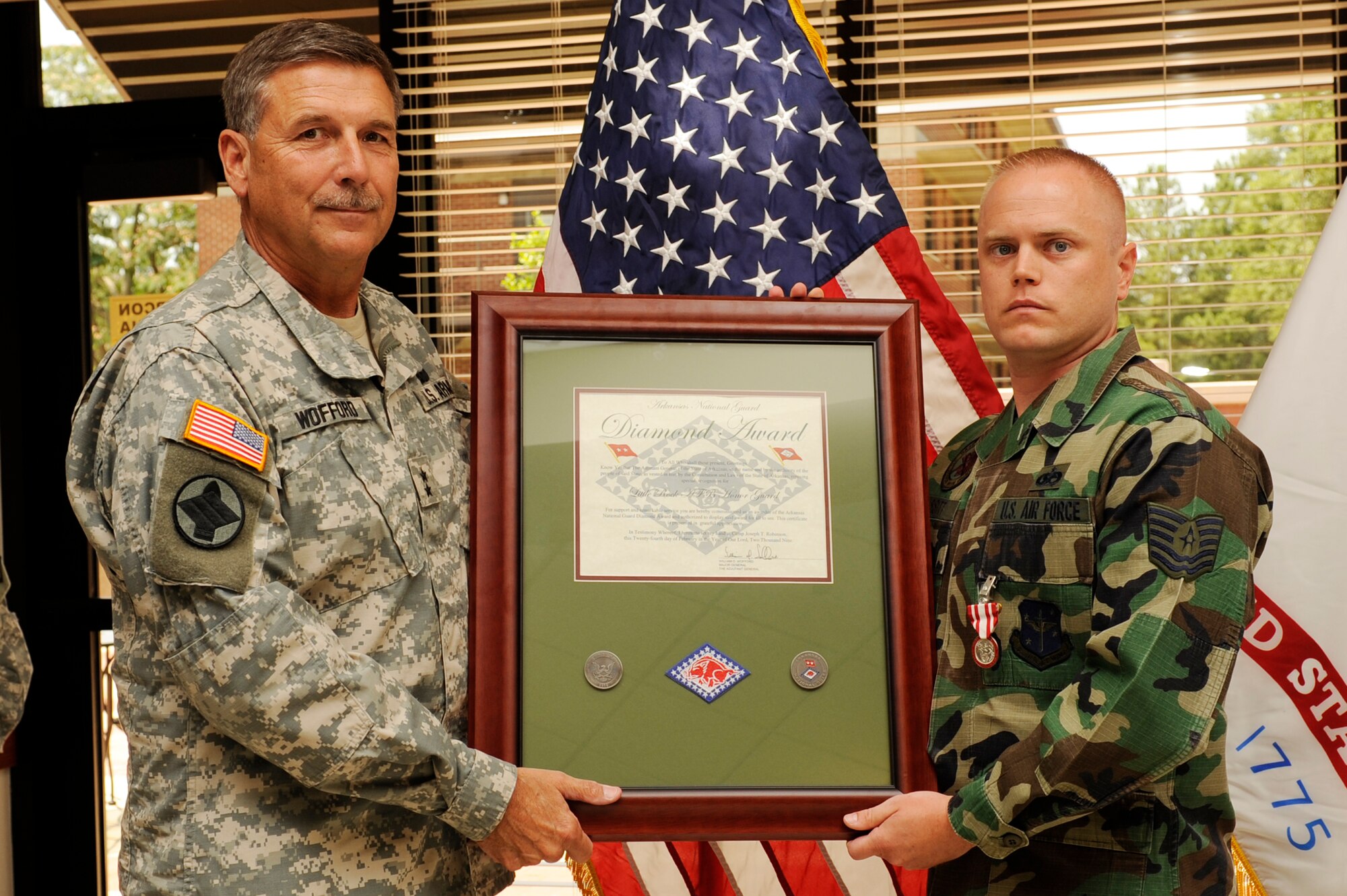 Army Maj. Gen. William Wofford, Adjutant General of the Arkansas National Guard, presents the the Arkansas Army National Guard Diamond Award to Tech. Sgt. Brandon Issitt of the Little Rock Air Force Base Honor Guard June 30 at the Hercules Dining Facility. (U.S. Air Force photo by Airman Lausanne Pacheco)