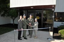From left: M. Britt Covington, Arnold Engineering Development Center’s  (AEDC) executive director, joins AEDC Commander Col. Art Huber, Lt. Col. James Colebank, the 718th Test Squadron commander and Lt. Col. Saroya Follender, the 704th Civil Engineering Squadron commander in a ribbon-cutting ceremony. The event marked the 718th’s official move to Building 1088, the former DECADE nuclear weapons effects testing facility. (Photo by Rick Goodfriend)