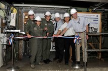 Arnold Engineering Development Center (AEDC) Commander Col. Art Huber, third from left, presided over a ribbon-cutting ceremony at the von Kàrmàn Gas Dynamics Facility (VKF) Tunnel A July 1. The event marked a multi-year-long project to modernize the tunnel’s model injection and test article control systems. (From left) Other participants included Navy Cmdr. Steven Kroll, the deputy director of 704th Test Systems Group, 716th Test Squadron Commander Lt. Col. Vanessa Bond, Aerospace Testing Alliance Deputy General Manager Steve Pearson, Simon Choi, Arnold’s Air Force investment program manager, and ATA Flight Systems Group Lead for Investment Projects Frank Wonder.(Photo by Rick Goodfriend)