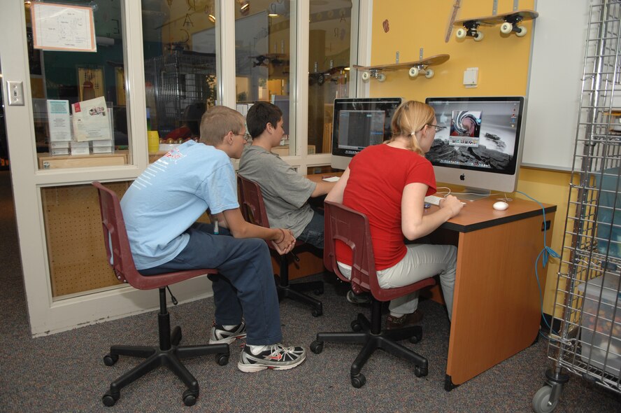 MINOT AIR FORCE BASE, N.D. -- Young people take advantage applications called "widgets" on new Apple Computers at the David C. Jones Youth Center here July 8. The youth center recently received seven new Apple computers for children to use for homework and fun. (U.S. Air Force photo by Staff Sgt. Angel Gallardo)