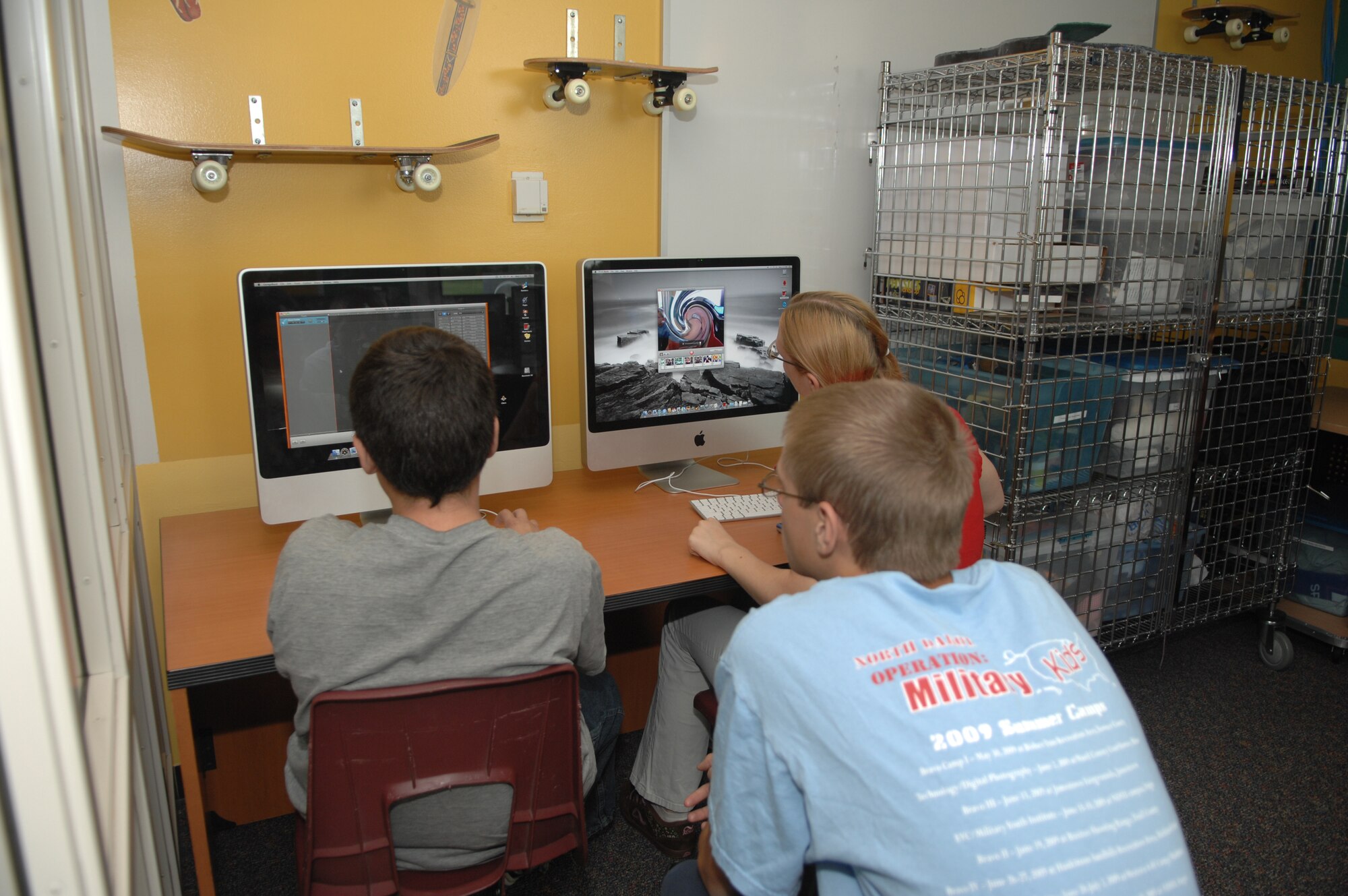 MINOT AIR FORCE BASE, N.D. -- Young people take advantage applications called "widgets" on new Apple Computers at the David C. Jones Youth Center here July 8. The youth center recently received seven new Apple computers for children to use for homework and fun. (U.S. Air Force photo by Staff Sgt. Angel Gallardo)