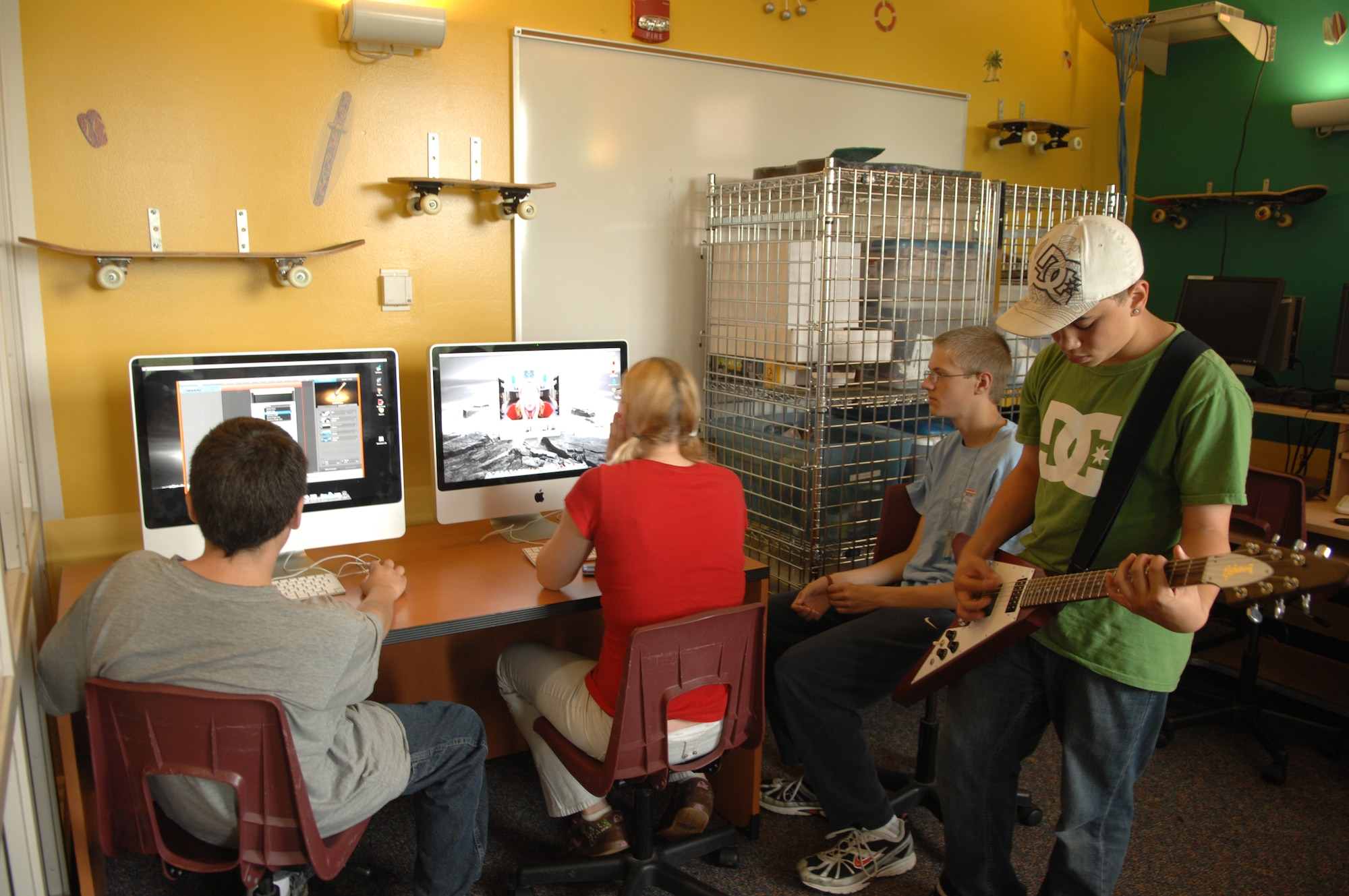 MINOT AIR FORCE BASE, N.D. -- Young people take advantage of the "Garage Band" Application on new Apple Computers at the David C. Jones Youth Center here July 8. The youth center recently received seven new Apple computers for children to use for homework and fun. (U.S. Air Force photo by Staff Sgt. Angel Gallardo)