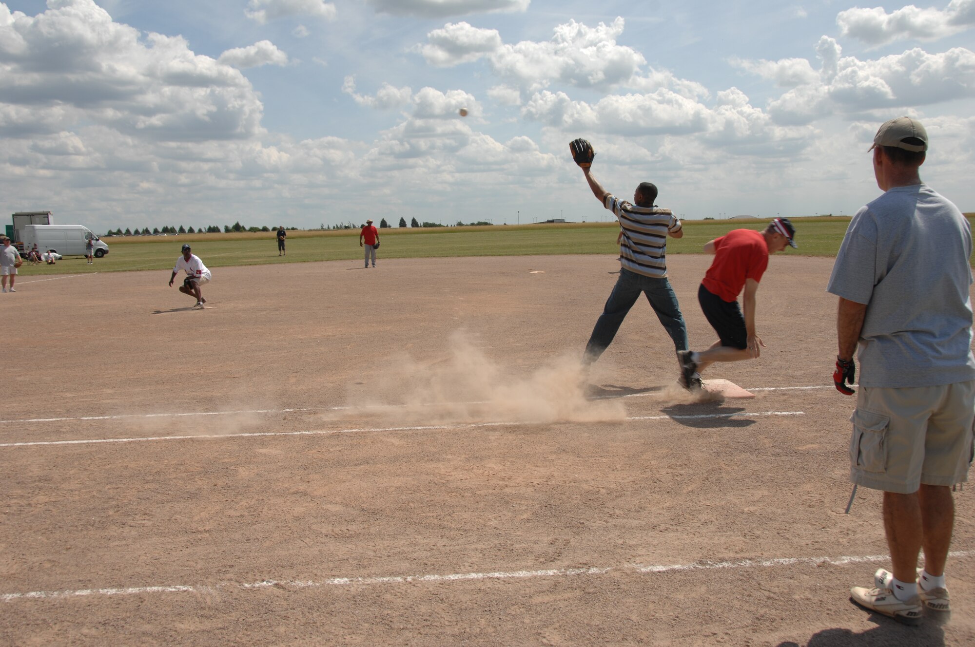 Col. Scott Reed, 48th Fighter Wing vice commander, makes it to first base safely during the Chiefs versus Eagles softball game July 4, 2009. Members of the local community and military came together to celebrate the American Independence Day festivities at RAF Feltwell, England. (USAF photo by Tech. Sgt. Christopher A. Campbell)