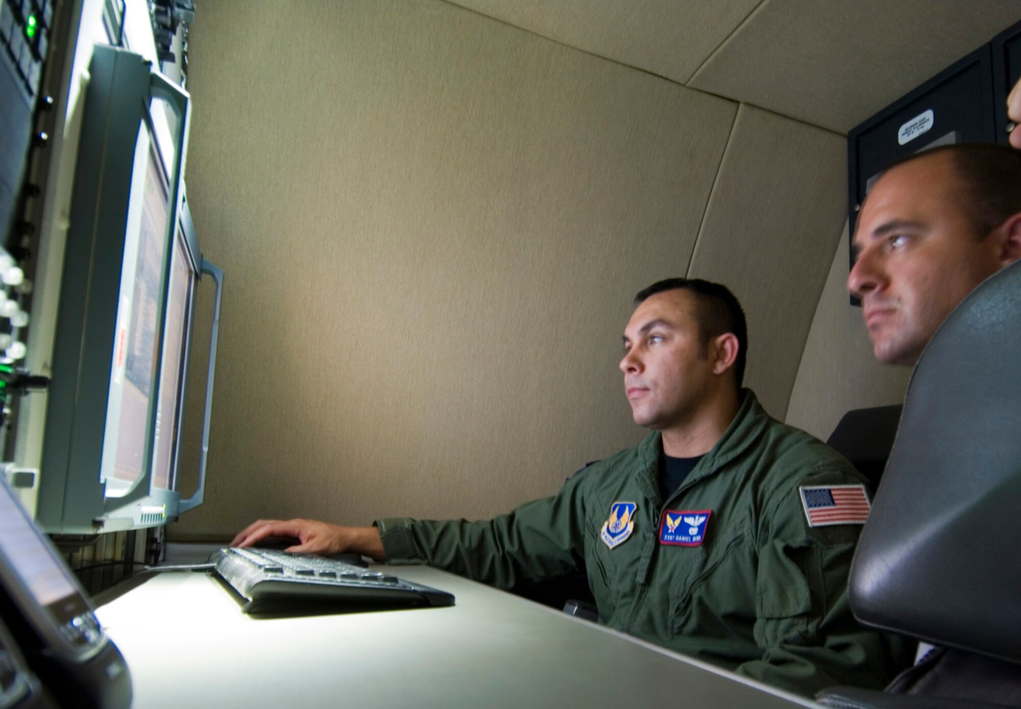Staff Sgt. Daniel A Wowk (left) describes features of Test Tanker II to 2nd Lt. Dan Elias of the SCP Program office June 30 at Hanscom Air Force Base, Mass. The Hanscom AFB-based program team will use Test Tanker II to test standardized command, control and communications equipment that will be incorporated on a special fleet of aircraft used to transport senior U.S. officials. Sergeant Wowk is a communications systems operator from the 412th Flight Test Squadron out of Edwards AFB, Calif. (U.S. Air Force photo/Rick Berry)