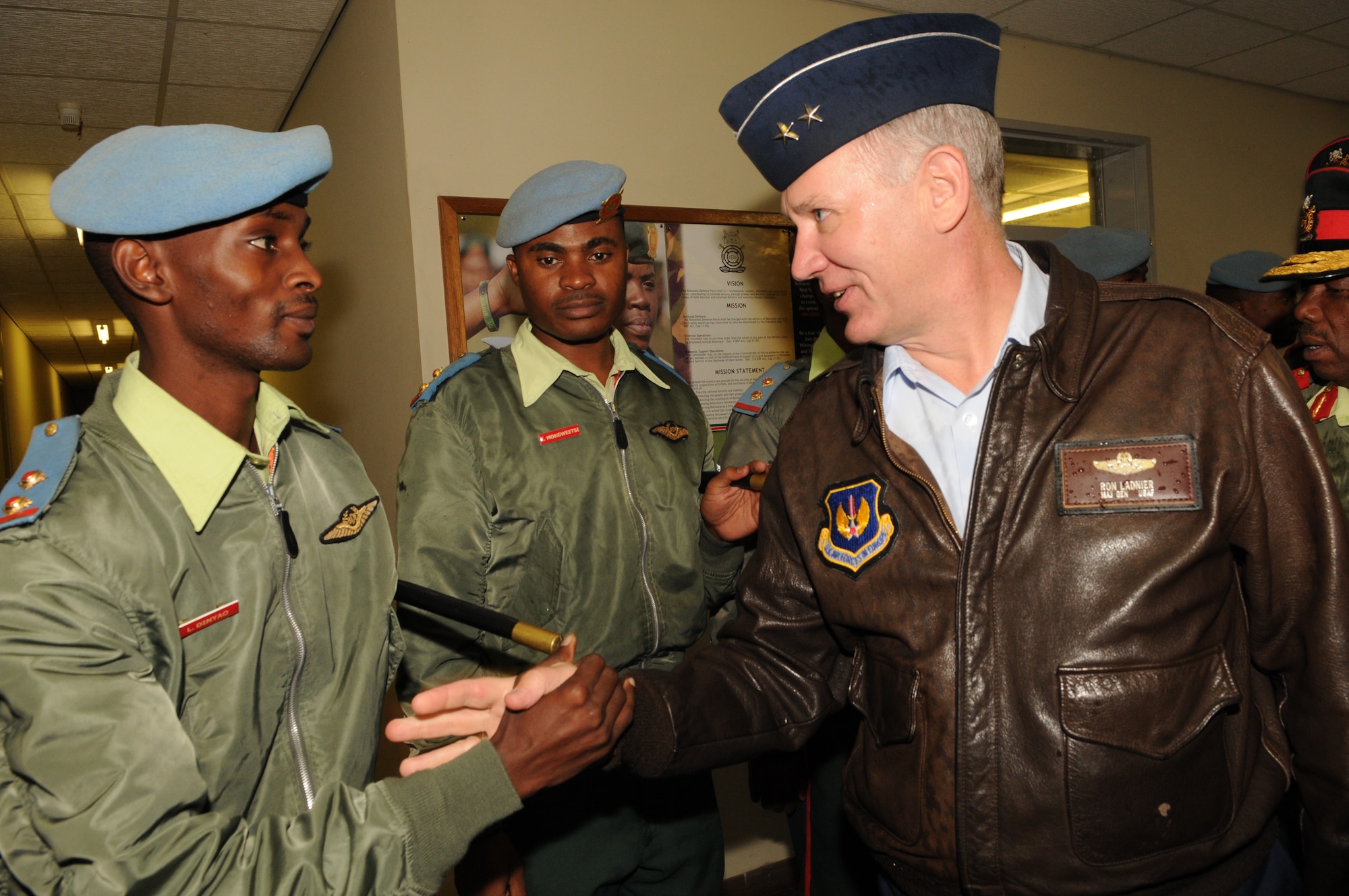 A Botswana Defense Force member shares a handshake in the local custom with Air Forces Africa Commander Maj. Gen. Ronald Ladnier during his senior leader engagement visit to Botswana June 9.