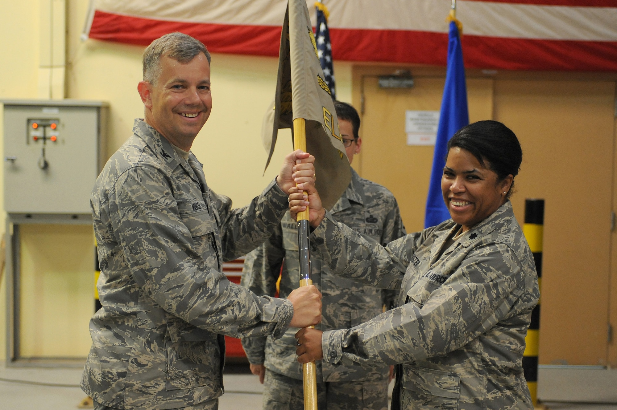 SOUTHWEST ASIA - Lt. Col. Hilary Feaster takes command of the 380th Expeditionary Logistics Readiness Squadron as she receives the squadron guidon from Col. Eric Pierce, 380th Expeditionary Mission Support Group, commander, July 6 in Southwest Asia. Colonel Feaster comes from Shaw AFB, Texas to lead the Airmen of the 380th ELRS. (U.S. Air Force photo by Senior Airman Brian J. Ellis)
