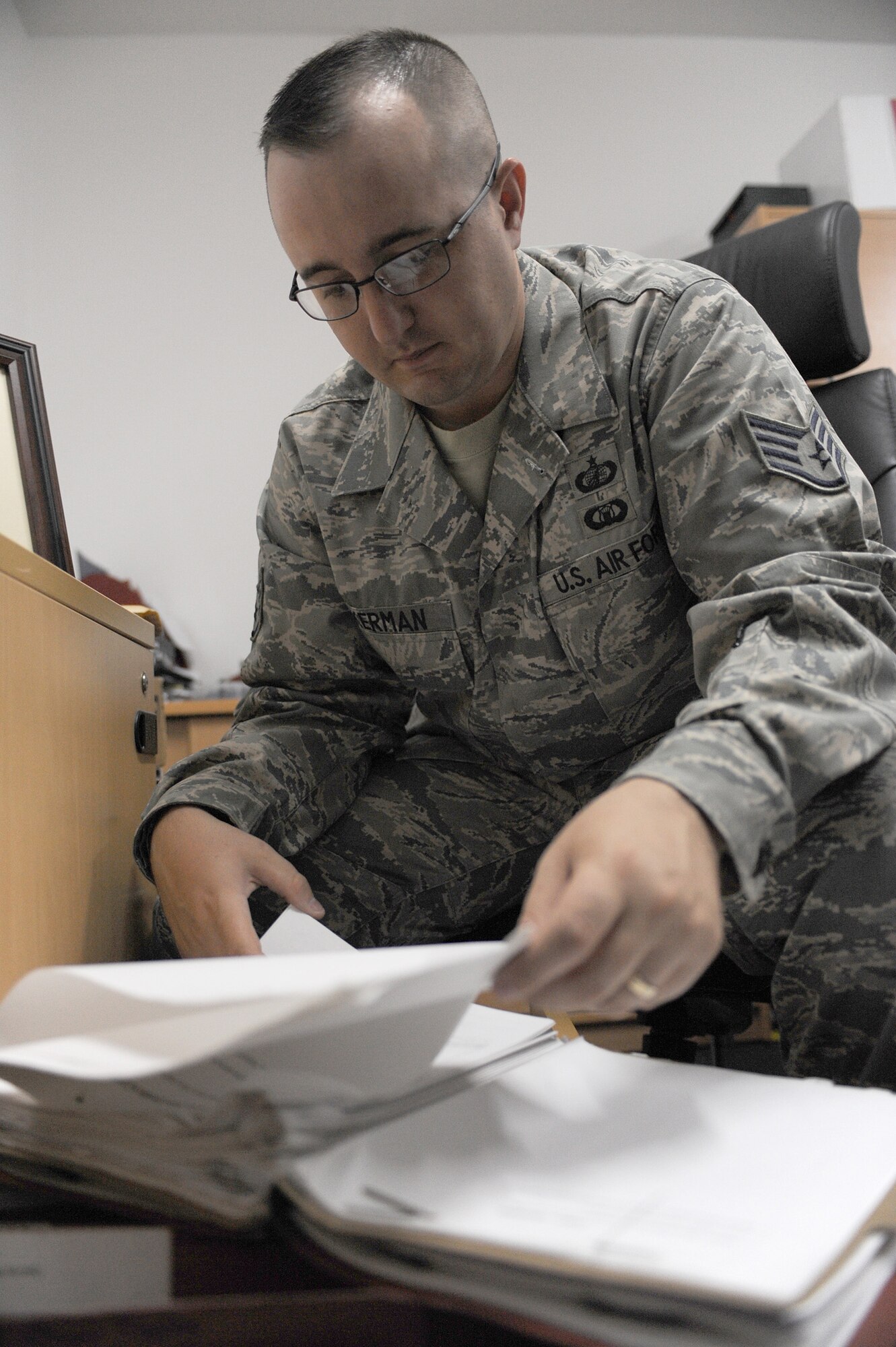 SOUTHWEST ASIA - Staff Sgt. Benjamin Ackerman, 380th Expeditionary Contracting Squadron, reviews a contract, July 6. Sergeant Ackerman works with vendors to provide equipment and supplies for the 380th mission. (U.S. Air Force photo by Senior Airman Brian J. Ellis)