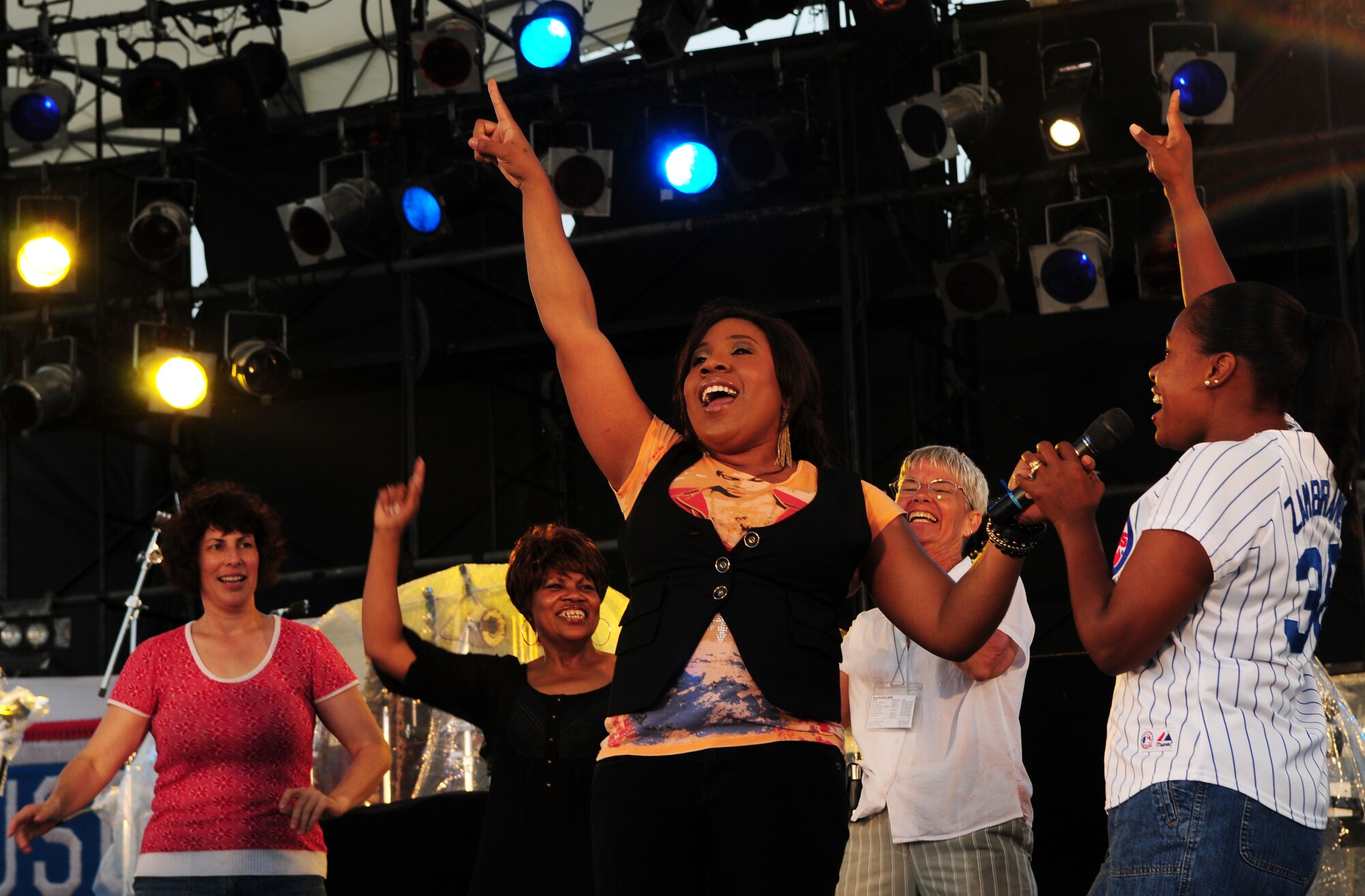 American Idol contestant Melinda Doolittle brings individuals from the crowd onstage to sing during her performance at AmericaFest 2009 at Kadena Air Base July 4. July 9 at Kadena Air Base, Japan. (U.S. Air Force photo/Staff Sgt. Lakisha Croley)                         