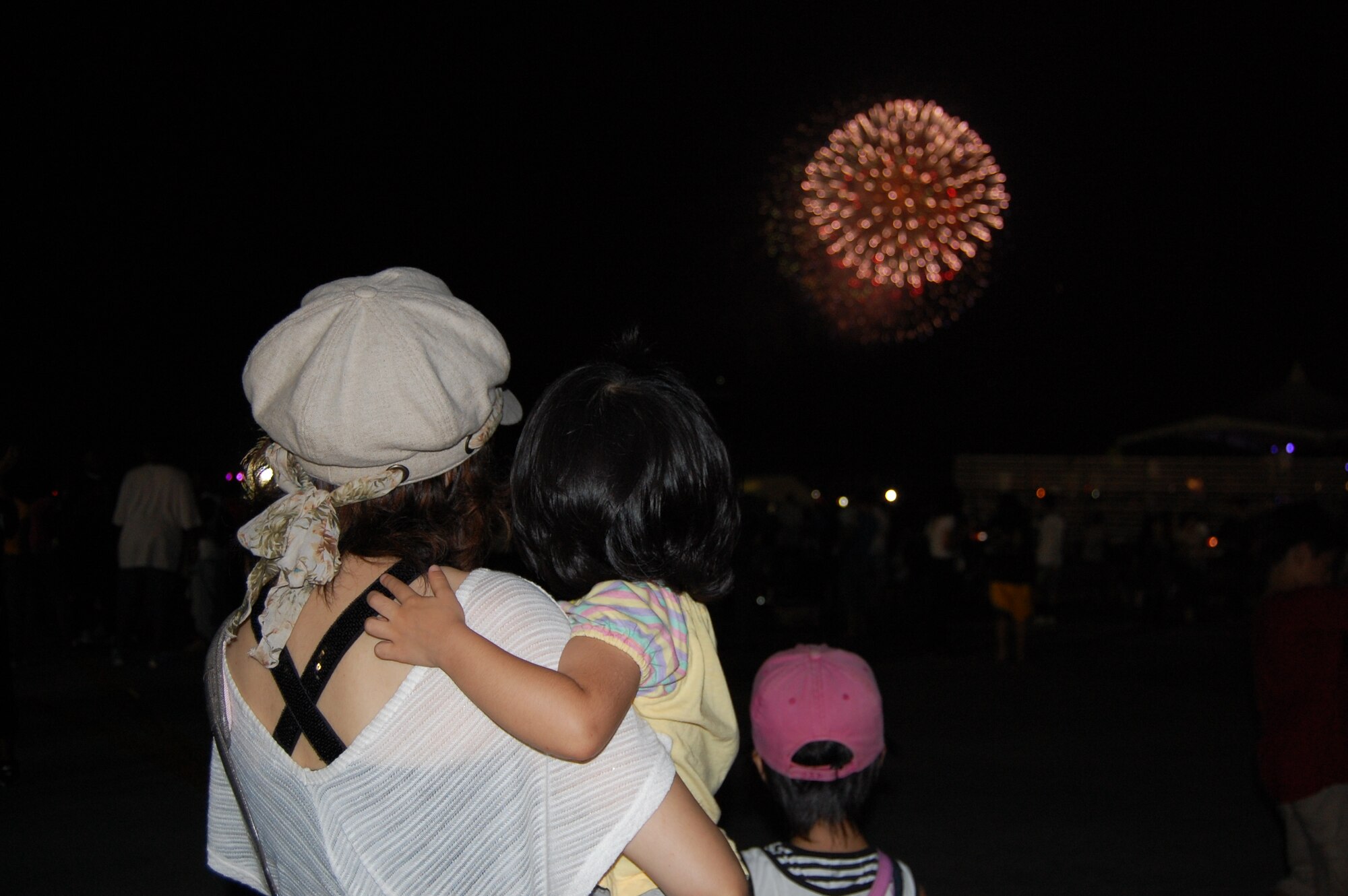 A family enjoys the fireworks display for U.S. and Okinawans during Americafest 09' at Kadena Air Base, Japan, July 4. 
(U.S. Air Force Photo/Tech. Sgt. Angelique Perez) 