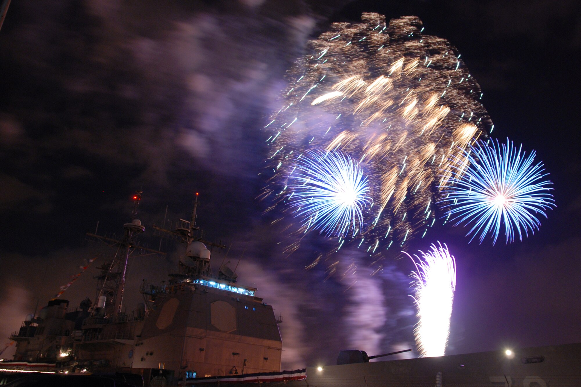 NAVAL AIR STATION PEARL HARBOR, Hawaii -- Fireworks erupt into a shower of colors behind the USS LAKE ERIE (CG 70), an Aegis-class guided missile cruiser based at Naval Station Pearl Harbor during the July 4 Celebration of Lights fireworks show. The day-long celebration was filled with live entertainment, exotic car display, a car show, pony rides, petting zoo, radio controlled car racing, games and much more. (U.S. Air Force photo by Staff Sgt. Mike Meares)  