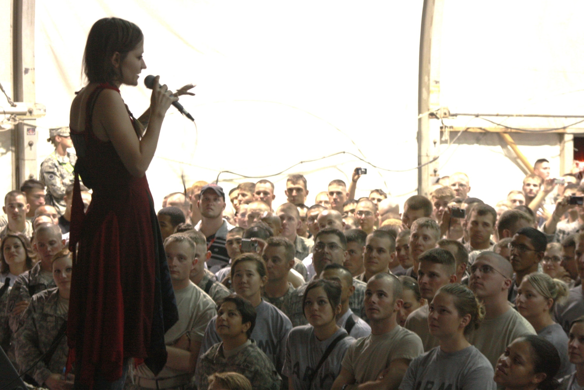 BAGRAM AIR FIELD, Afghanistan -- Flyleaf vocalist Lacey Sturm performs in front of hundreds on Bagram Air Field, Afghanistan, July 6, wrapping up their first overseas tour for troops. (Photo by U.S. Army Capt. Michael Greenberger)
