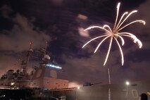NAVAL AIR STATION PEARL HARBOR, Hawaii -- Fireworks erupt into a shower of colors behind the USS LAKE ERIE (CG 70), an Aegis-class guided missile cruiser based at Naval Station Pearl Harbor during the July 4 Celebration of Lights fireworks show. The day-long celebration was filled with live entertainment, exotic car display, a car show, pony rides, petting zoo, radio controlled car racing, games and much more. (U.S. Air Force photo by Staff Sgt. Mike Meares)  