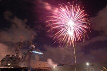 NAVAL AIR STATION PEARL HARBOR, Hawaii -- Fireworks erupt into a shower of colors behind the USS LAKE ERIE (CG 70), an Aegis-class guided missile cruiser based at Naval Station Pearl Harbor during the July 4 Celebration of Lights fireworks show. The day-long celebration was filled with live entertainment, exotic car display, a car show, pony rides, petting zoo, radio controlled car racing, games and much more. (U.S. Air Force photo by Staff Sgt. Mike Meares)  