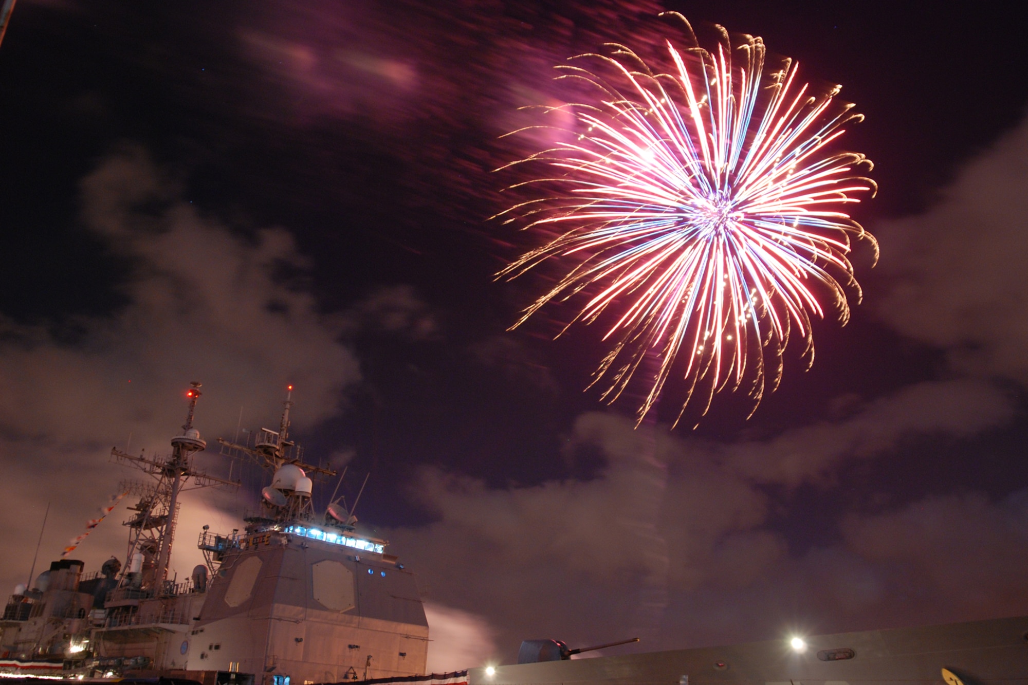 NAVAL AIR STATION PEARL HARBOR, Hawaii -- Fireworks erupt into a shower of colors behind the USS LAKE ERIE (CG 70), an Aegis-class guided missile cruiser based at Naval Station Pearl Harbor during the July 4 Celebration of Lights fireworks show. The day-long celebration was filled with live entertainment, exotic car display, a car show, pony rides, petting zoo, radio controlled car racing, games and much more. (U.S. Air Force photo by Staff Sgt. Mike Meares)  