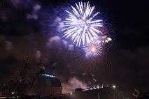 NAVAL AIR STATION PEARL HARBOR, Hawaii -- Fireworks erupt into a shower of colors behind the USS LAKE ERIE (CG 70), an Aegis-class guided missile cruiser based at Naval Station Pearl Harbor during the July 4 Celebration of Lights fireworks show. The day-long celebration was filled with live entertainment, exotic car display, a car show, pony rides, petting zoo, radio controlled car racing, games and much more. (U.S. Air Force photo by Staff Sgt. Mike Meares)  