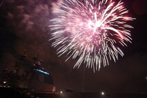NAVAL AIR STATION PEARL HARBOR, Hawaii -- Fireworks erupt into a shower of colors behind the USS LAKE ERIE (CG 70), an Aegis-class guided missile cruiser based at Naval Station Pearl Harbor during the July 4 Celebration of Lights fireworks show. The day-long celebration was filled with live entertainment, exotic car display, a car show, pony rides, petting zoo, radio controlled car racing, games and much more. (U.S. Air Force photo by Staff Sgt. Mike Meares)  