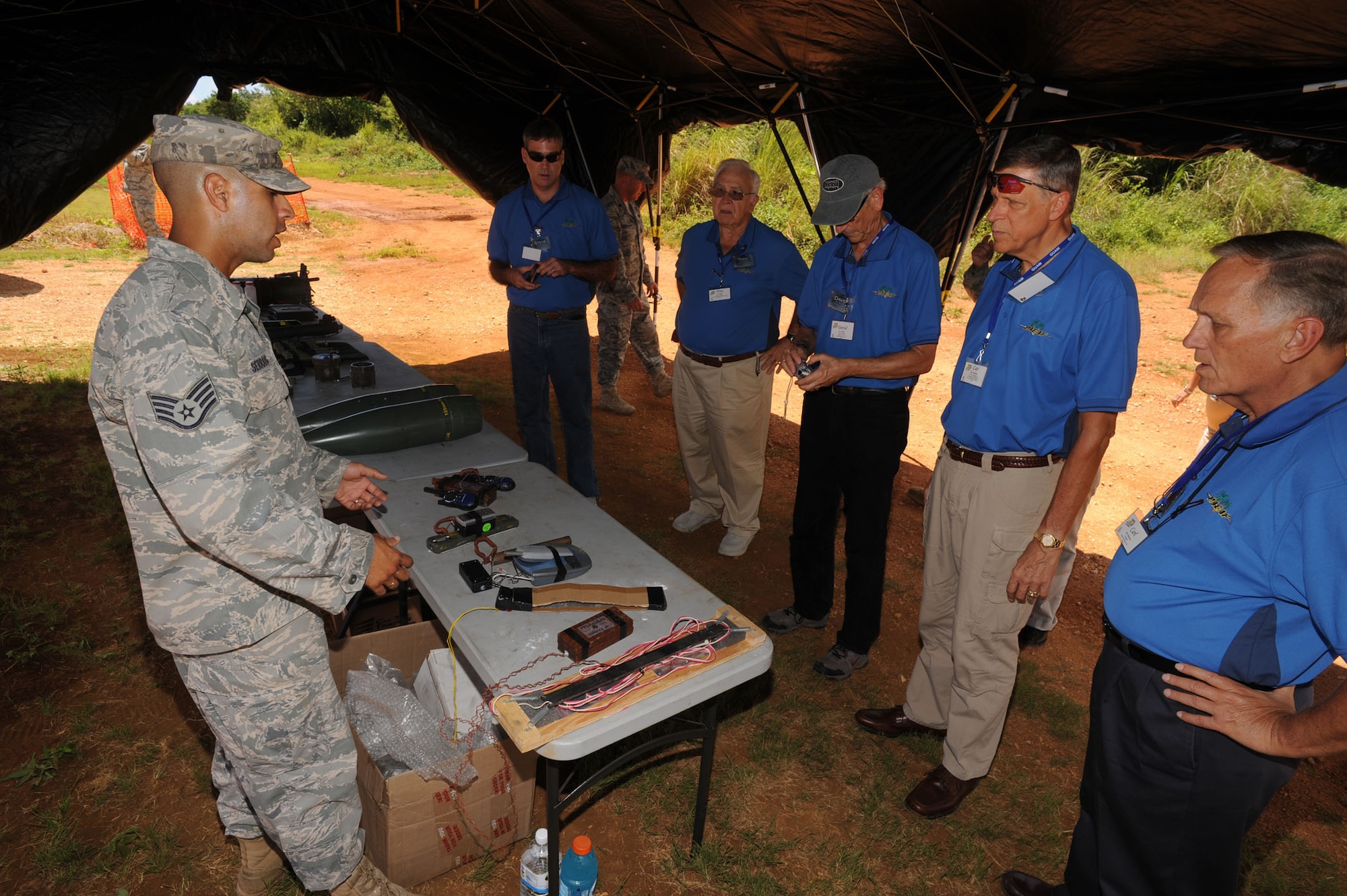 Staff Sgt. Marcus Serrano, 736th Security Forces Squadron, shows civic leaders the tools the Pacific Air Force Regional Training Center cadre uses to educate Airmen on the dangers they may face while deployed.  Twenty two regional civic leaders visited Andersen June 26 as part of a five day tour of the Pacific theater including stops in Andersen Air Force Base, Guam, Elmendorf and Eielson AFBs, Alaska, and Hickam AFB, Hawaii, tour to show how each location contributes to the Pacific theater.  The Strategic Triangle Civic Leadership tour was hosted by Gen. Howie Chandler, Pacific Air Forces commander.  (U.S. Air Force photo by Tech. Sgt. Michael Boquette/36th Wing Public Affairs)