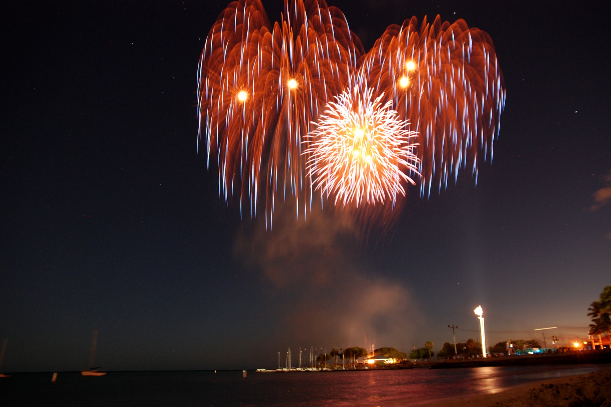 HICKAM AIR FORCE BASE, Hawaii -- Fireworks explode over Hickam Harbor during the grand finale of the All American Beach Blast July 4. The All American Beach Blast, hosted by 15th Services Squadron, began with camping and a movie under the stars July 3. The celebration continued July 4 with food booths, live entertainment, a kiddieland play area, bounce houses, swimming, as well as powerboat, sailboat and banana boat rides in the harbor. (U.S. Air Force photo/Staff Sgt. Mike Meares)