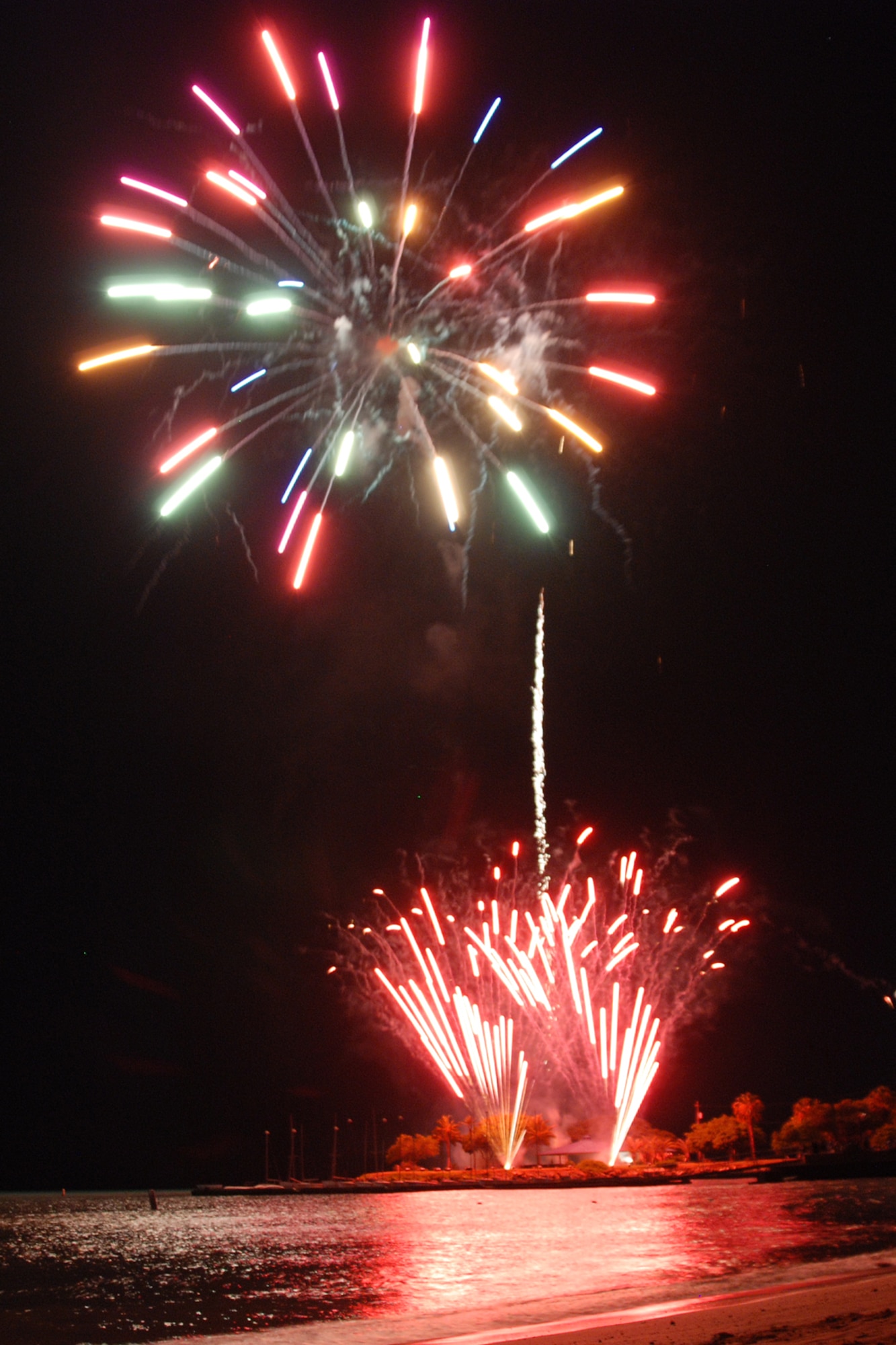 HICKAM AIR FORCE BASE, Hawaii -- Fireworks explode over Hickam Harbor during the grand finale of the All American Beach Blast July 4. The All American Beach Blast, hosted by 15th Services Squadron, began with camping and a movie under the stars July 3. The celebration continued July 4 with food booths, live entertainment, a kiddieland play area, bounce houses, swimming, as well as powerboat, sailboat and banana boat rides in the harbor. (U.S. Air Force photo/Staff Sgt. Mike Meares)