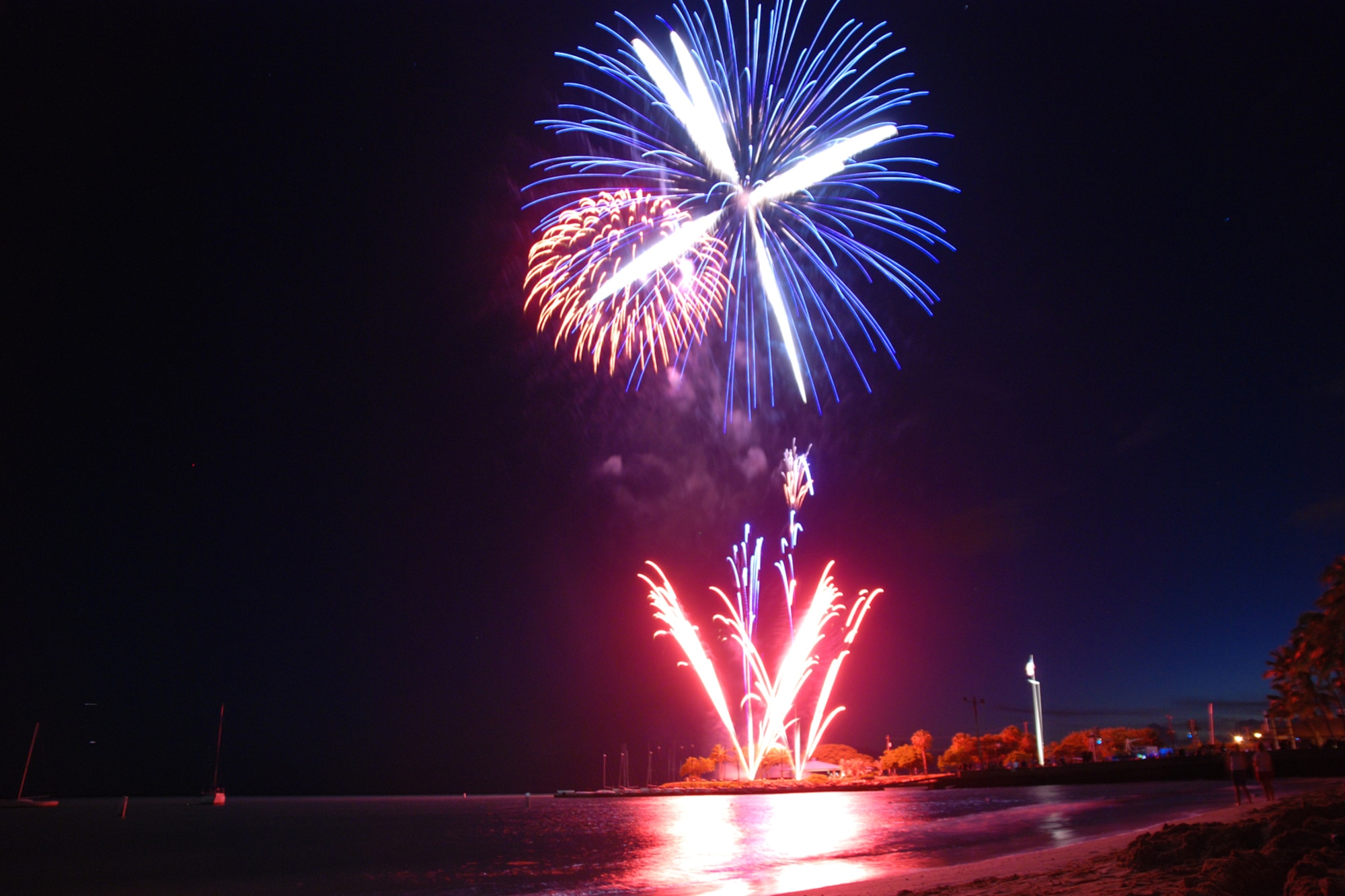 HICKAM AIR FORCE BASE, Hawaii -- Fireworks explode over Hickam Harbor during the grand finale of the All American Beach Blast July 4. The All American Beach Blast, hosted by 15th Services Squadron, began with camping and a movie under the stars July 3. The celebration continued July 4 with food booths, live entertainment, a kiddieland play area, bounce houses, swimming, as well as powerboat, sailboat and banana boat rides in the harbor. (U.S. Air Force photo/Staff Sgt. Mike Meares)